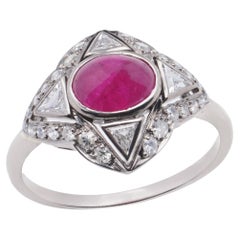 Art Deco inspired 18kt. white gold 0.75 carats oval cabochon ruby cluster ring