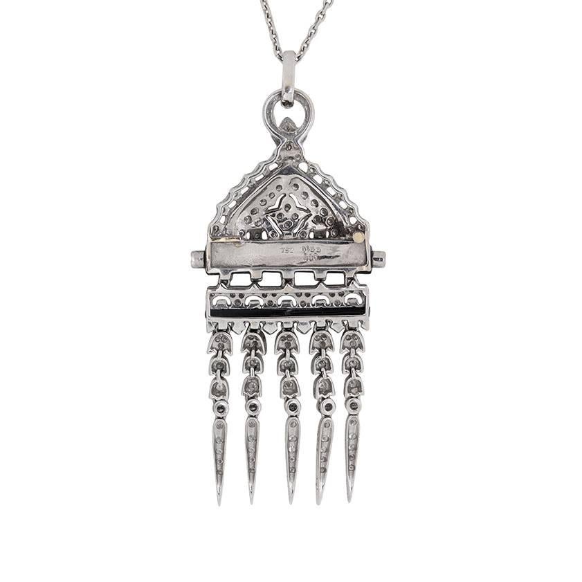 A modern emulation of high Art Deco style!

This beautiful and dramatic 18 carat white gold pendant glitters with 2.50 carats of round brilliant cut diamonds accented with onyx.

Five dagger-like tassels descend from an onyx bar amid a dynamic