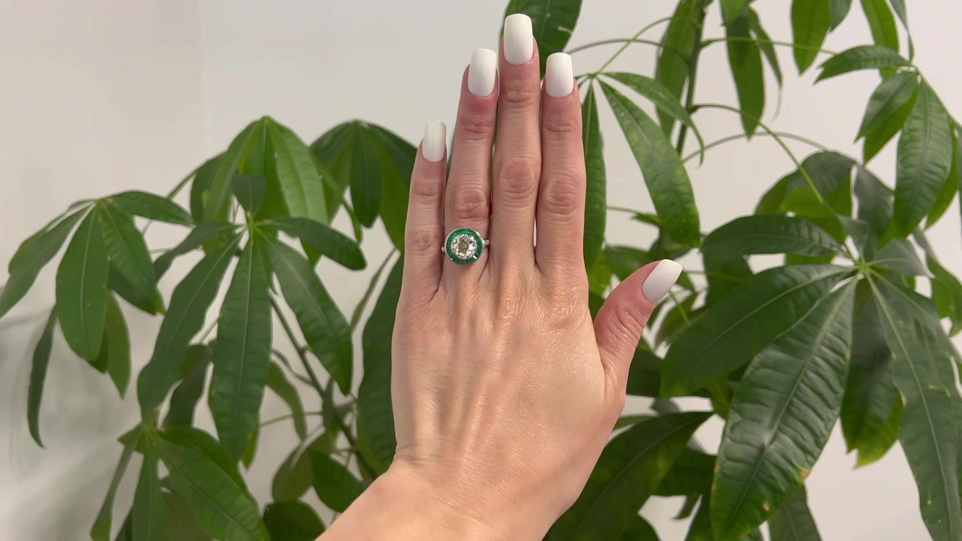 One Art Deco Inspired 2.51 Carats Old European Cut Diamond Emerald 14k White Gold Target Ring. Featuring one old European cut diamond of 2.51 carats, graded O-P color, SI2 clarity. Accented by 25 calibré cut emeralds with a total weight of
