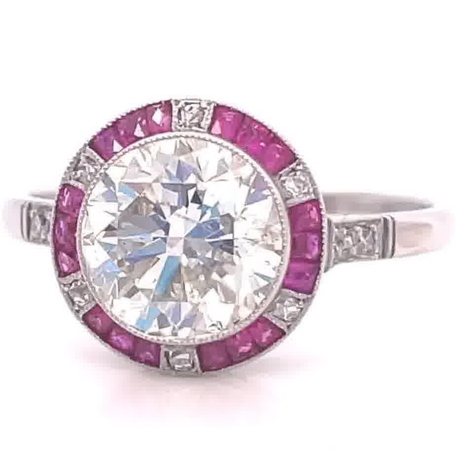 The perfect ring for someone with a bright lively personality. Radiate your sparkle and charisma with this Art deco inspired 2.81 carat transitional cut diamond ruby platinum ring. The diamond is approximately L-M color, SI2 clarity. Accented by 18