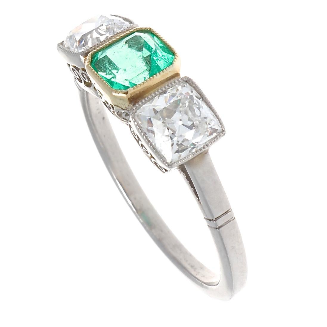 Sometimes a 3 stone ring comes along that delights beyond comprehension. At just over 0.50 carat, this green emerald cut treasure is accompanied by two of the sparkliest old European cut diamonds. A delicate mill grain bezel frames each stone. The