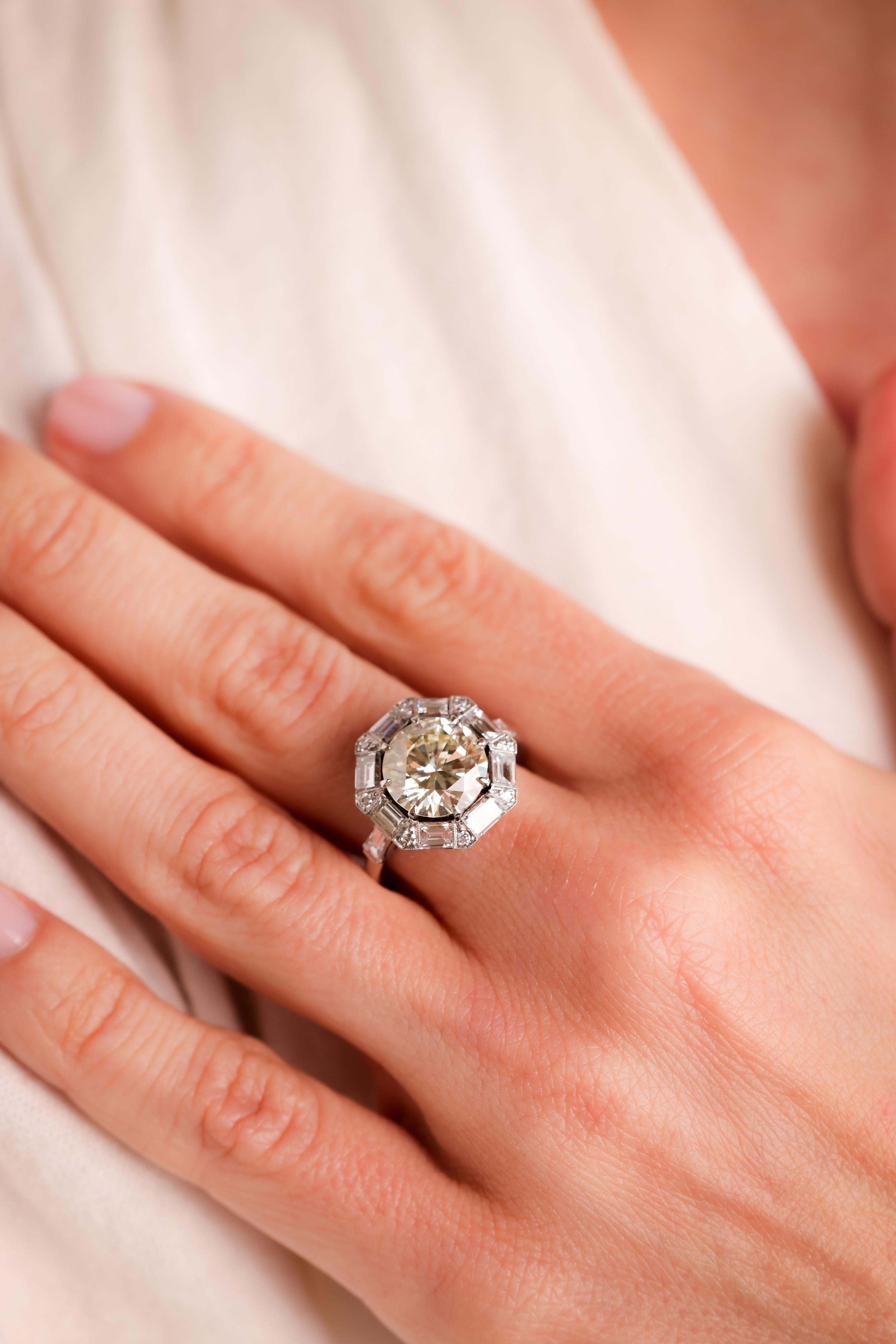 Center Stone: Diamond
Cut: Round Brilliant Cut
Weight: 3.46 Carat
Color: Q-R
Clarity: VS
Accent Stone: 10 Diamonds
Cut: Baguette Cut
Weight: Approximately 1.5 Carats
Color: I
Clarity: VS
Accent Stone: 8 Diamonds
Cut: Round Brilliant
Weight: