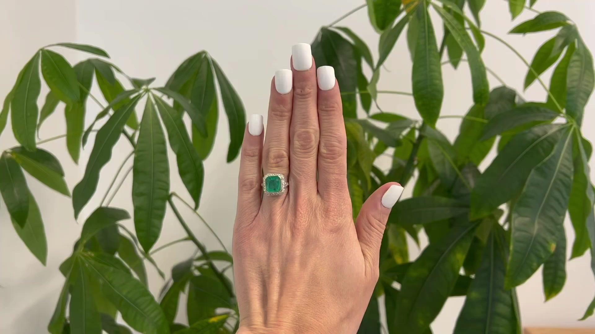 One Art Deco Inspired 4.27 Carats Emerald Diamond Platinum Halo Ring. Featuring one octagonal step cut emerald of 4.27 carats. Accented by 32 single cut diamonds with a total weight of approximately 0.70 carat, graded F color, VS clarity. Crafted in