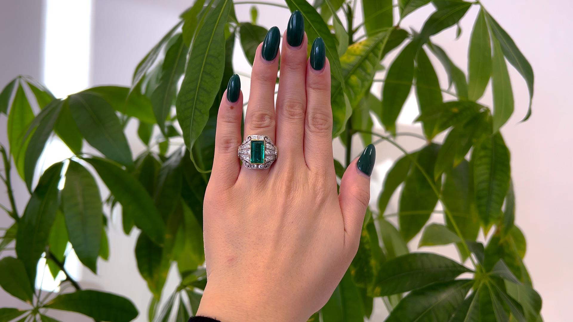One Art Deco Inspired AGL Colombian Minor Oil Emerald Diamond Platinum Ring. Featuring one AGL rectangular step cut emerald of 2.98 carats, accompanied with AGL #1101095 stating the emerald is of Colombian origin with minor oil. Accented by 52 old