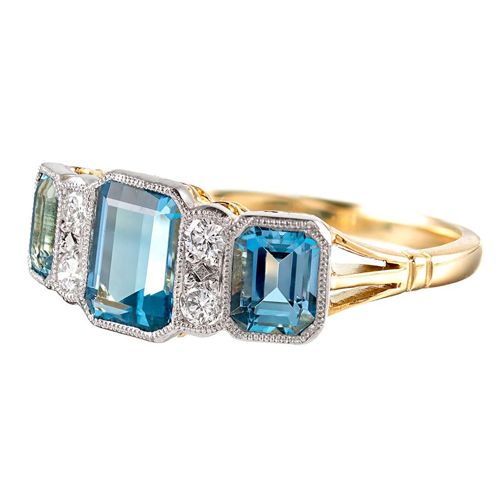 A modern rendering inspired by classic art deco style, this 18 karat yellow gold & platinum ring offers a lovely low profile on the finger, making it ideal for daily wear. Set with 1.79 carats of aquamarine and .15 carats of brilliant white
