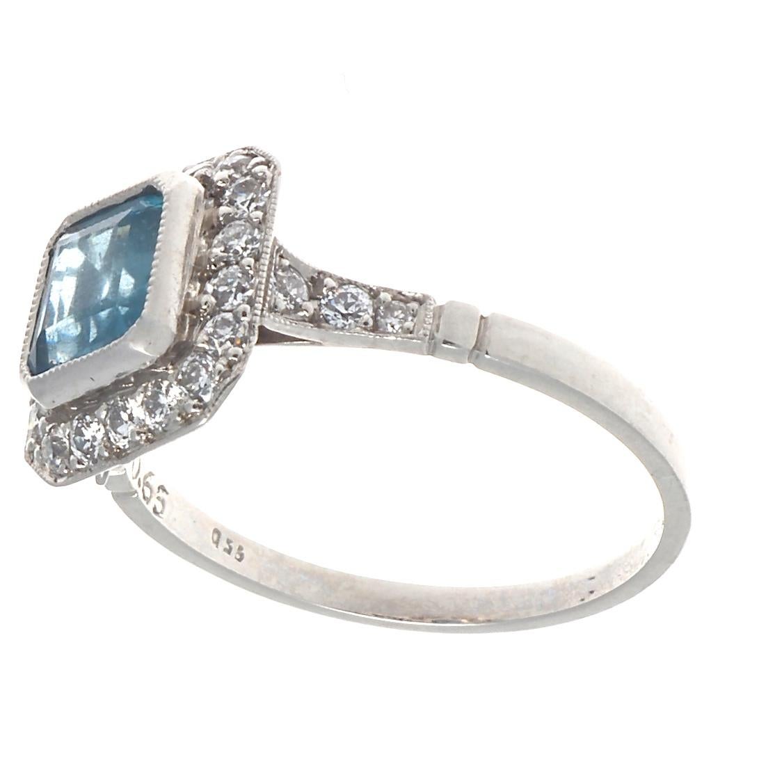 Beautiful aquamarine and diamond platinum ring, featuring one emerald cut aquamarine that weighs 0.65 carats. Elegantly accented with 24 old European cut diamonds that weigh approximately 0.30 carats and are graded as H-I color, VS clarity. This