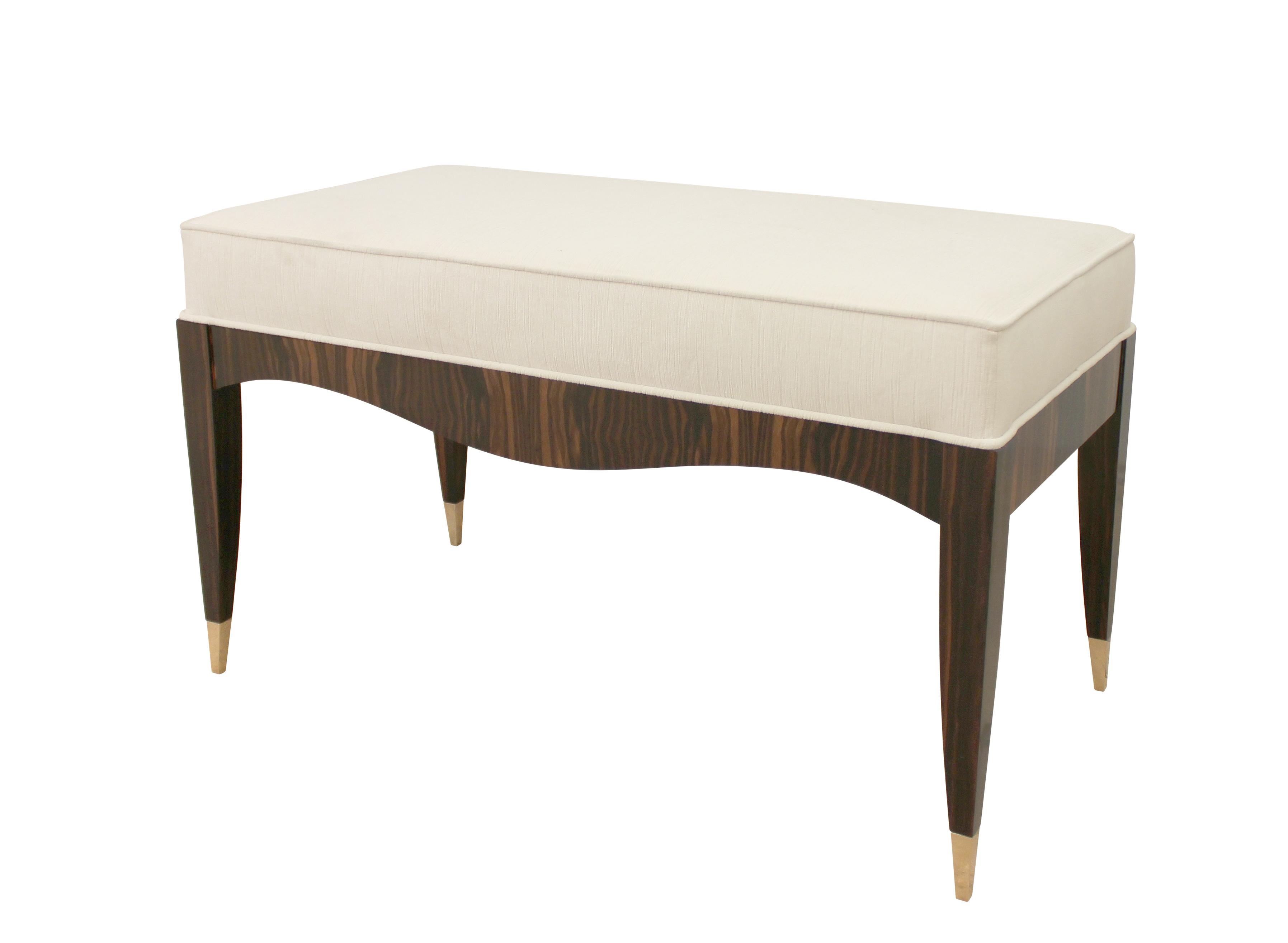 Art Deco Inspired Bench in Ebony Macassar Veneer with Cast Bronze Toe Caps is made with hardwood frame and veneered in book matched ebony Macassar veneer with satin lacquer finish. Polished and lacquered bronze toe caps draw the eye along the curves