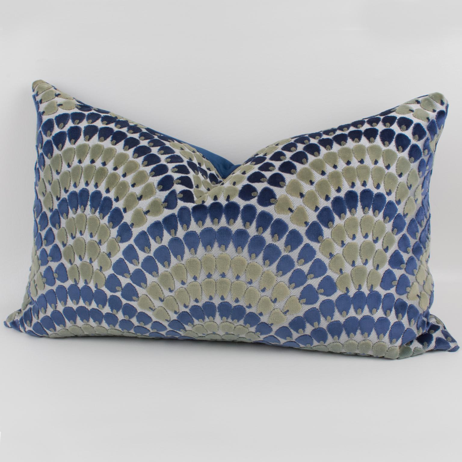 Lovely Art Deco-inspired throw pillow. This lumbar pillow is covered on the front with a textured arabesque geometric design in royal blue and almond green velvet. The back is of royal blue velvet. A zipper encloses an inner feather pillow. An