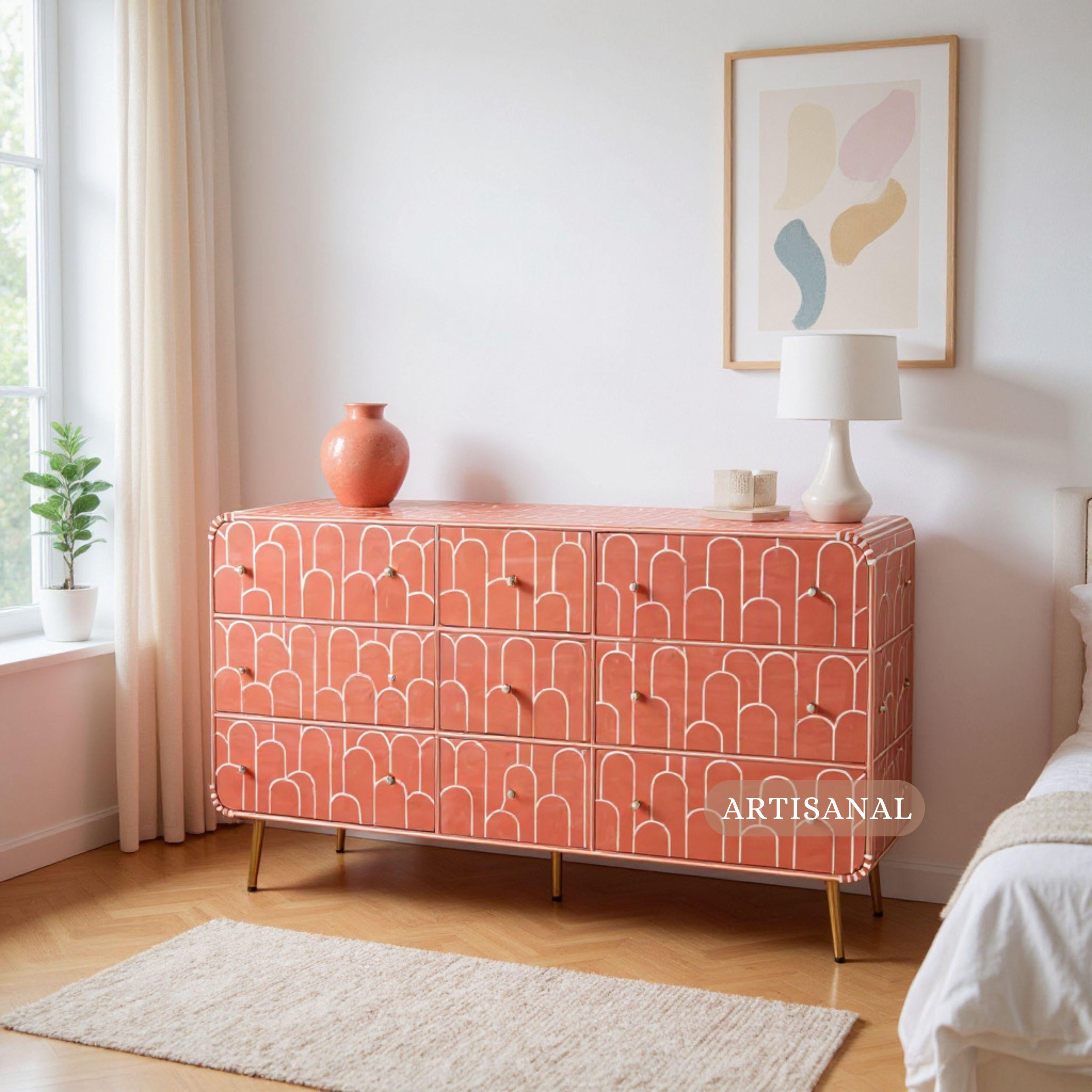 This striking dresser celebrates the timeless allure of Art Deco design, reimagined through contemporary craftsmanship. Handcrafted with precision, each drawer is adorned with a bold geometric bone inlay pattern in a warm coral hue, creating a