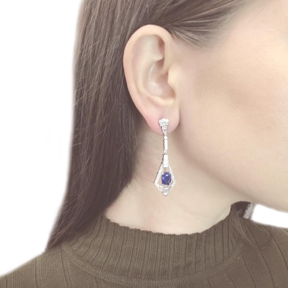 Stylish Art Deco inspired dangling drop platinum earrings.
Center oval cut blue Ceylon sapphire 5.89 ct in total.
Accented by baguette cut diamonds 1.82 ct in total.
Diamonds are white and natural and in G-H Color Clarity VS.
Platinum 950 metal.