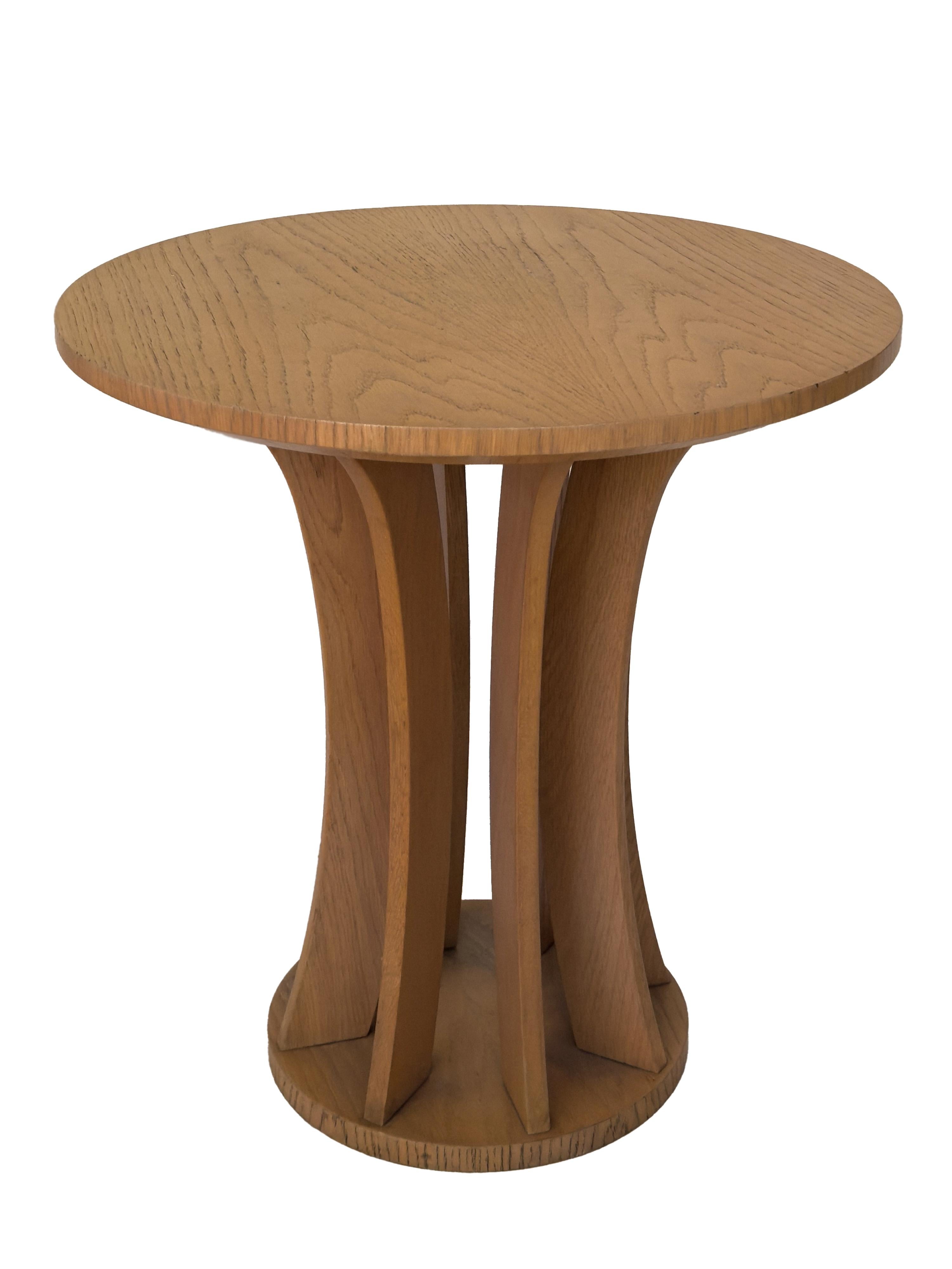 A refined French Art Deco inspired pine wood side table from the 20th century, finished in lustrous varnish and supported by gracefully rounded legs. Its bold geometric silhouette adds a touch of sophistication to any elegant interior.