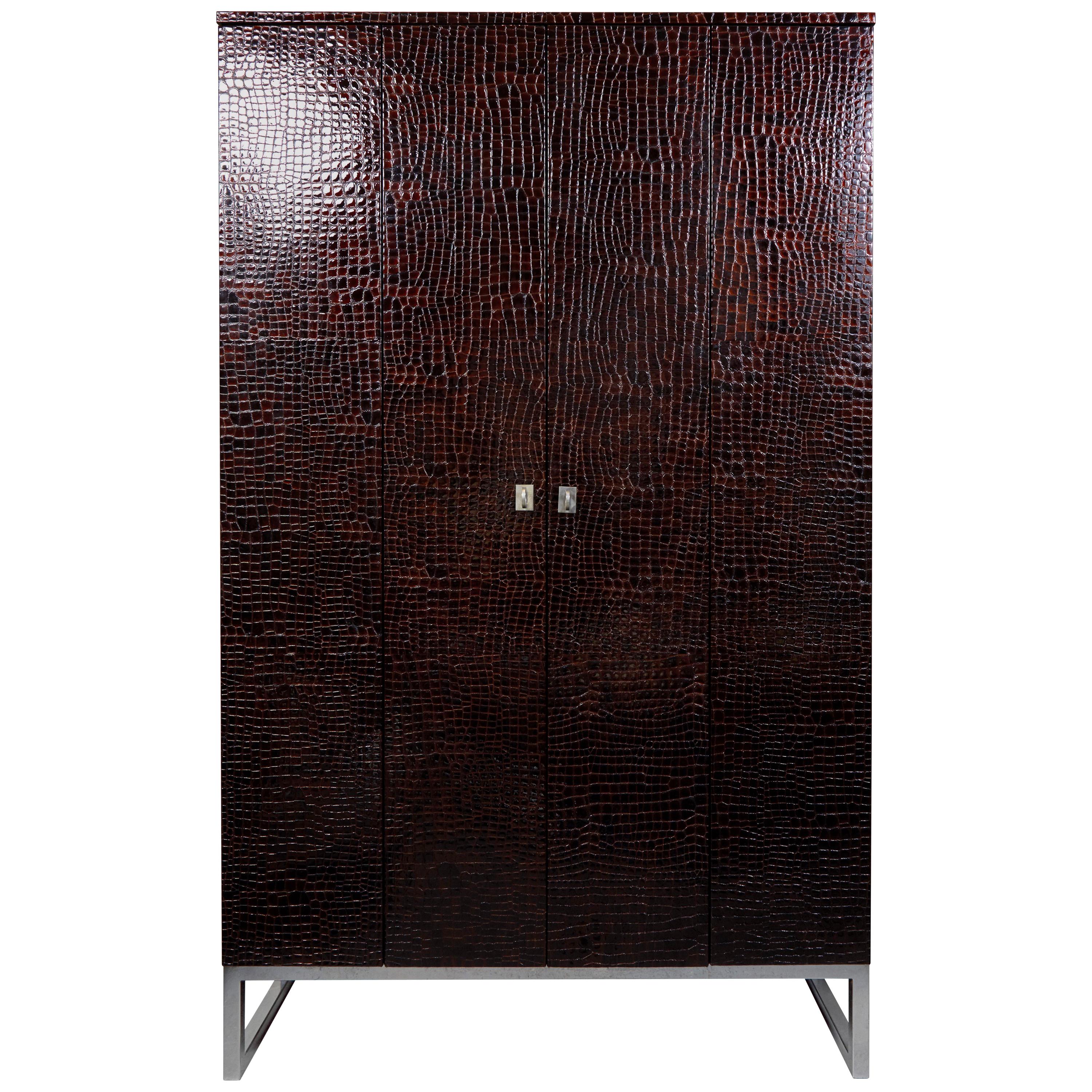 A unique crocodile finish bovine leather cabinet on a polished steel base with two doors and five shelves.