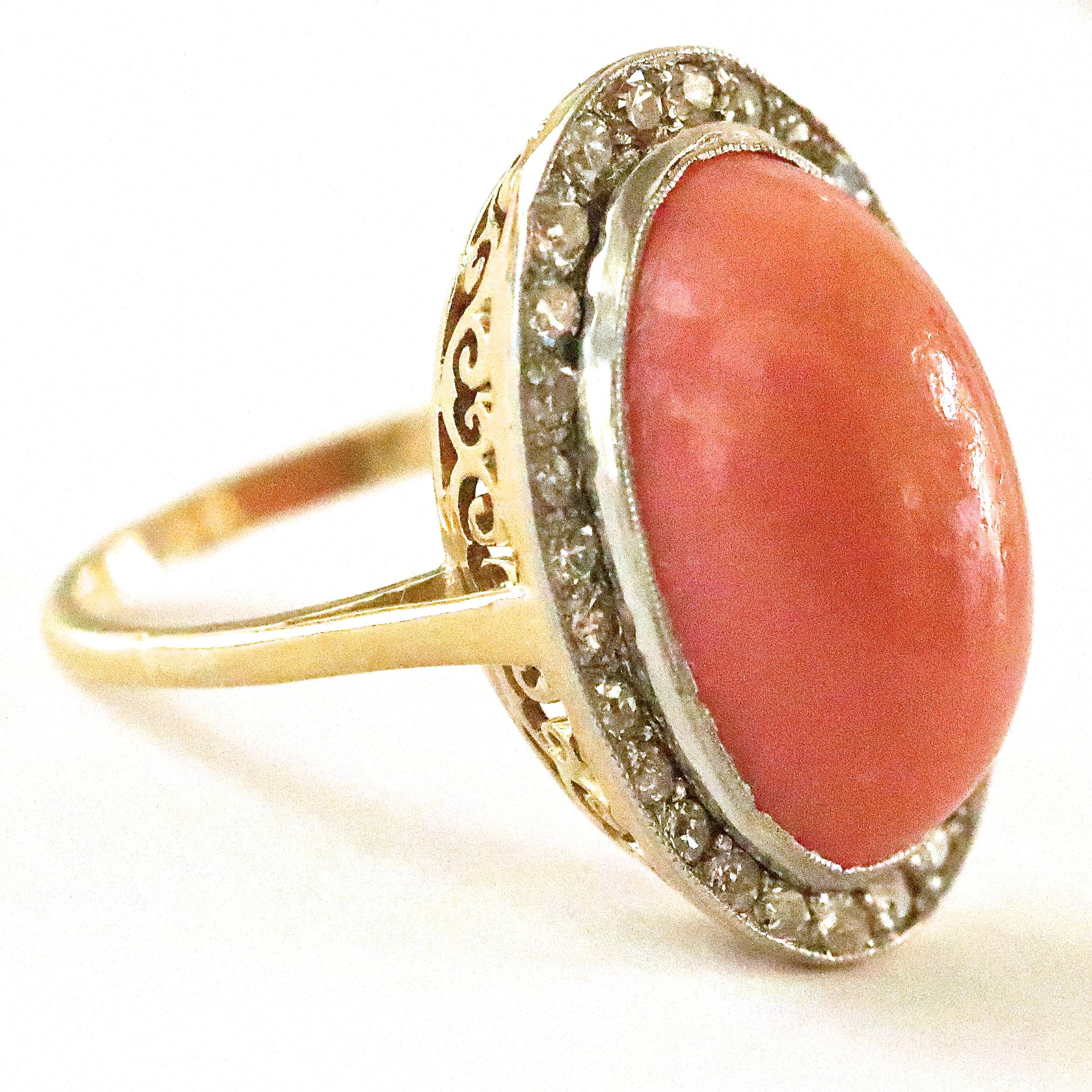 The Art Deco period was a time of advancement, symmetry and fun! This beautiful Art Deco Inspired Coral Diamond 18k gold Cluster Ring is perfect for a night out. The center stone is a cabochon coral approximately 10.00 carats. Highlighted by 28
