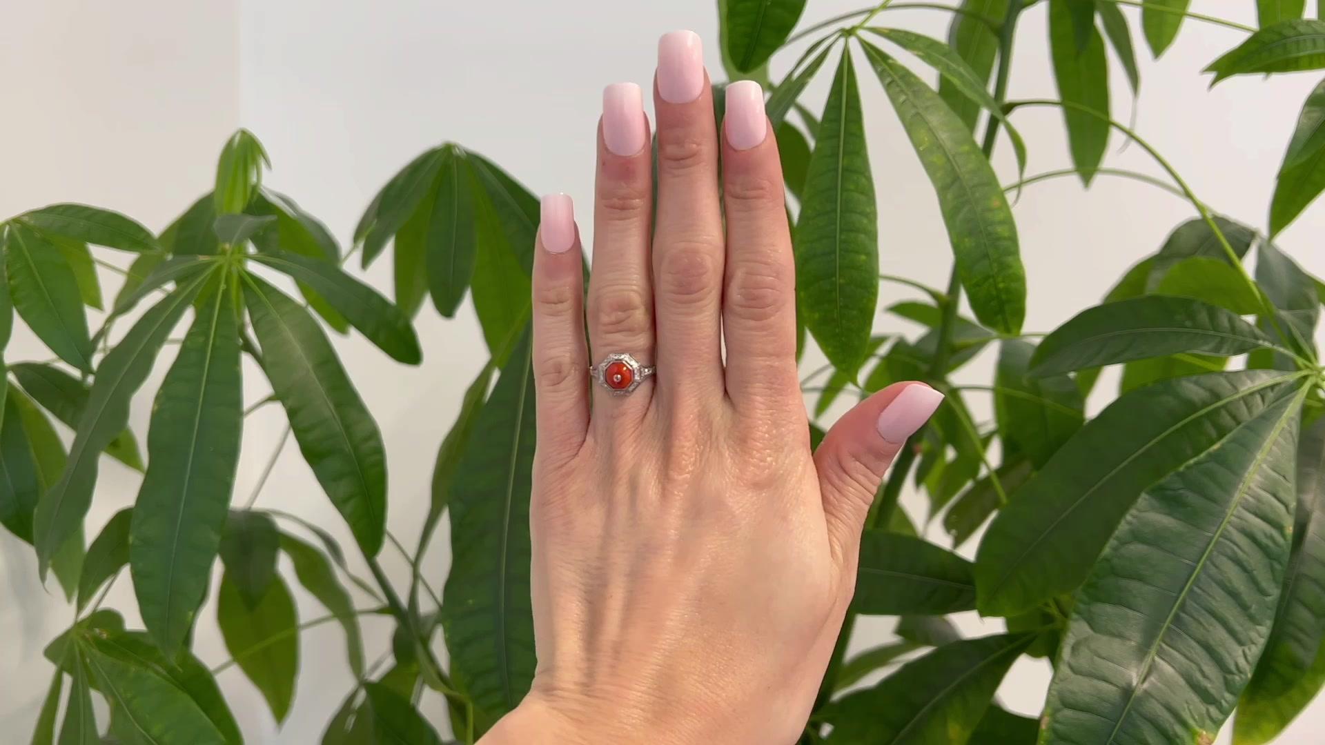 One Art Deco Inspired Coral Diamond Platinum Ring. Featuring one cabochon cut coral piece. Accented by 22 single cut diamonds with a total weight of approximately 0.30 carat, graded F color, VS clarity. Crafted in platinum with purity marks. Circa