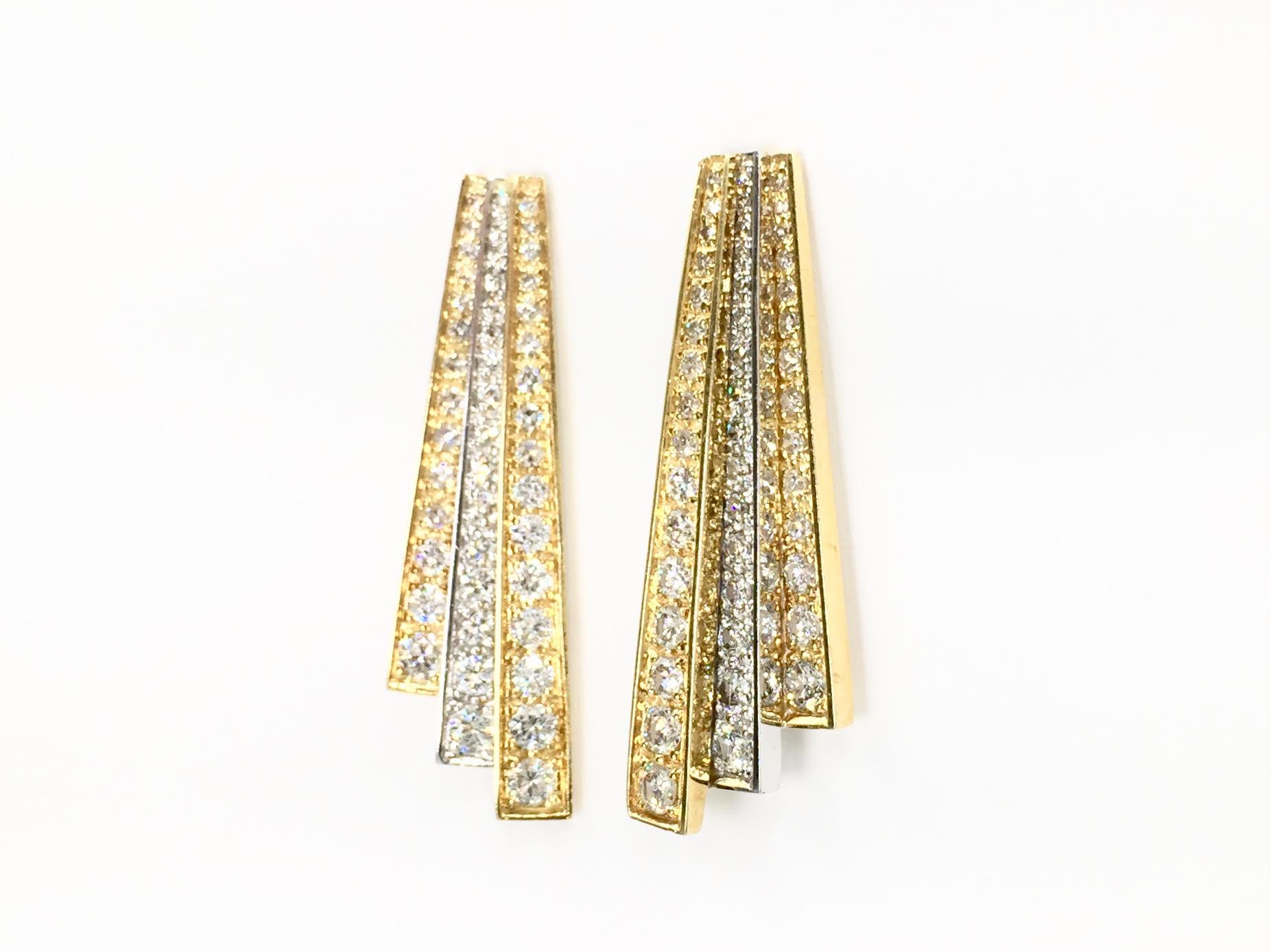 Clean and classic Art Deco inspired 18 karat two tone drop earrings with three rows of diamonds, approximately 3.50 carats total weight. Each earring contains 46 beautiful round brilliant diamonds at approximately G color, SI1 clarity. Earrings have