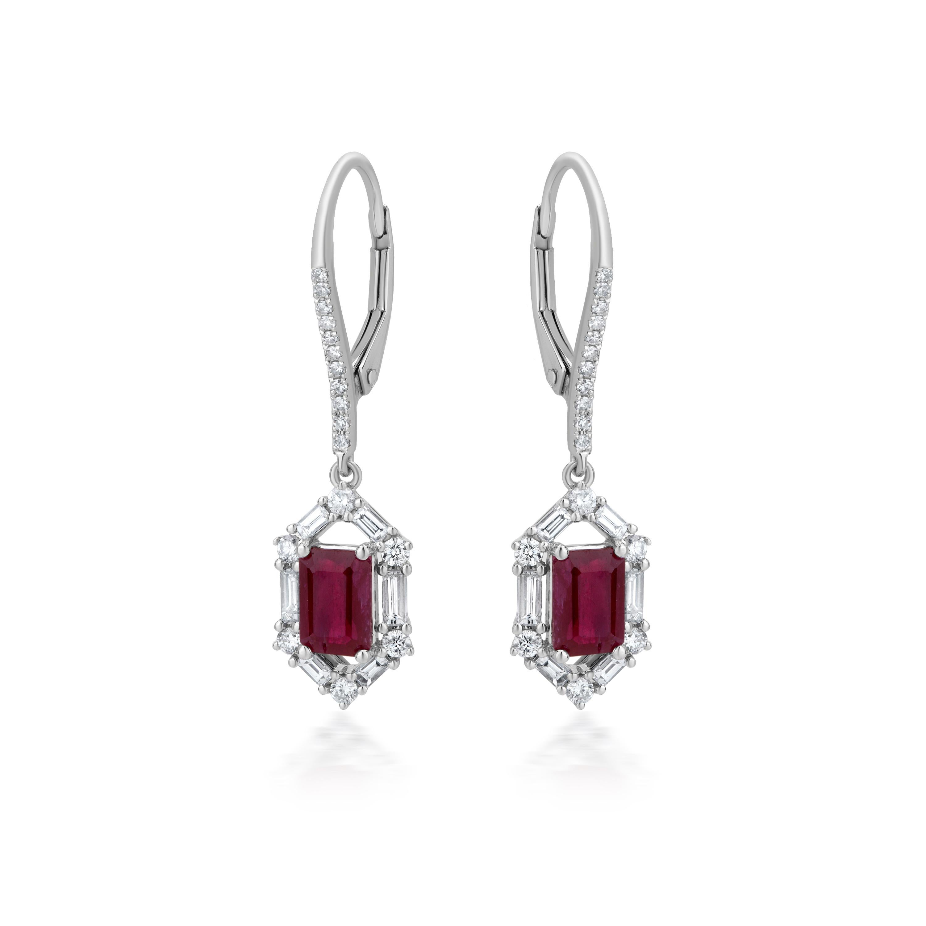 A gorgeous pair of Gemistry 18k white gold earrings set in prongs with 46 round diamonds and baguettes, as well as a lovely red ruby is safe under the diagonal shape. It has a lovely liver back. The diamonds have a GH color grade and I1, SI1