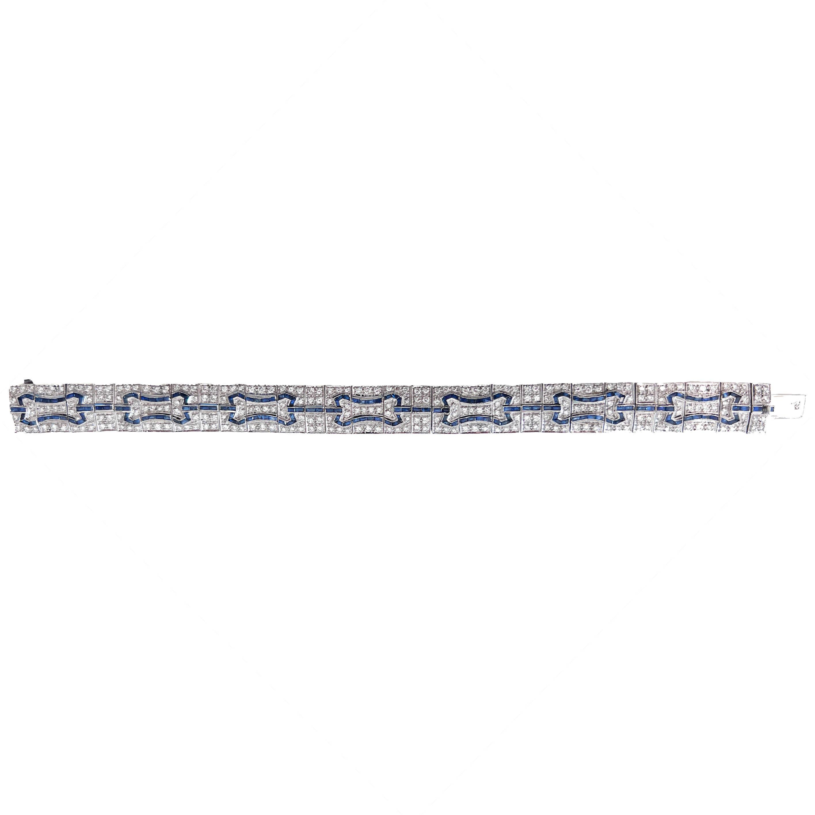This stunning Art Deco-inspired diamond and sapphire bracelet captures the glamour and sophistication of the 1920s, crafted as a reproduction in the 1980s-1990s. Meticulously designed with 266 sparkling bead-set diamonds totaling approximately 4