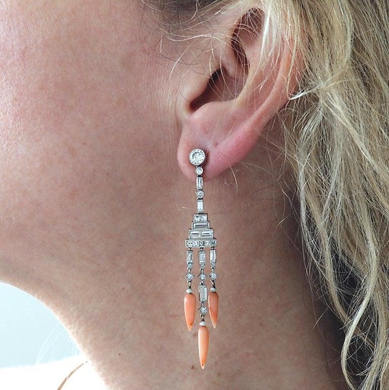 Art Deco inspired Diamond Coral Pearl Chandelier Earrings. Featuring 38 baguette cut diamonds and 14 old European cut diamonds, F/G color, VS-SI clarity. The larger diamonds are approximately 0.35 carats each. There are also three seed pearls on