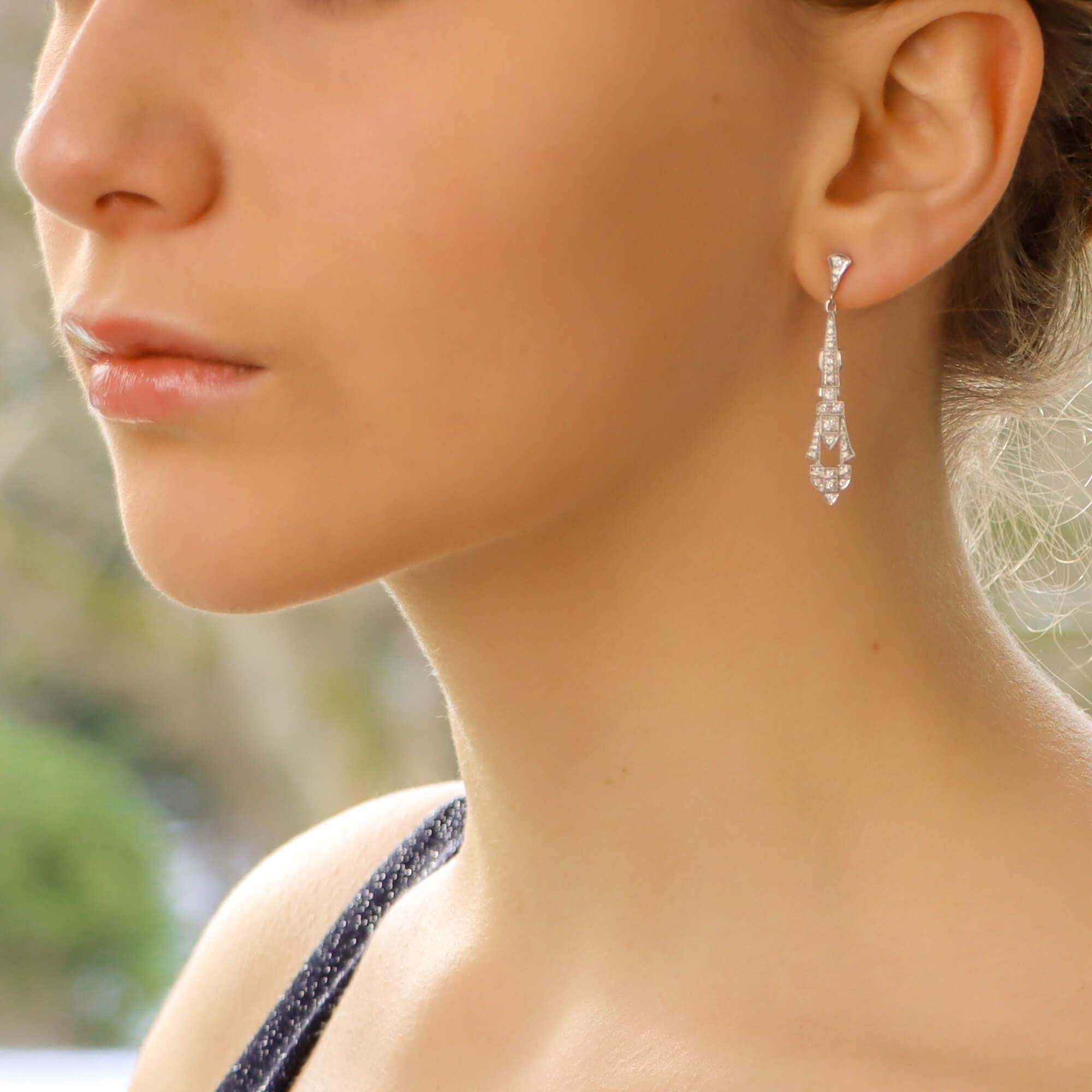 A beautiful pair of Art Deco inspired diamond drop earrings set in 18k white gold.

Each earring is set with exactly 31 round brilliant cut diamonds; all of which are pavé set within a beautiful Art Deco style drop. The beauty of these earrings lies