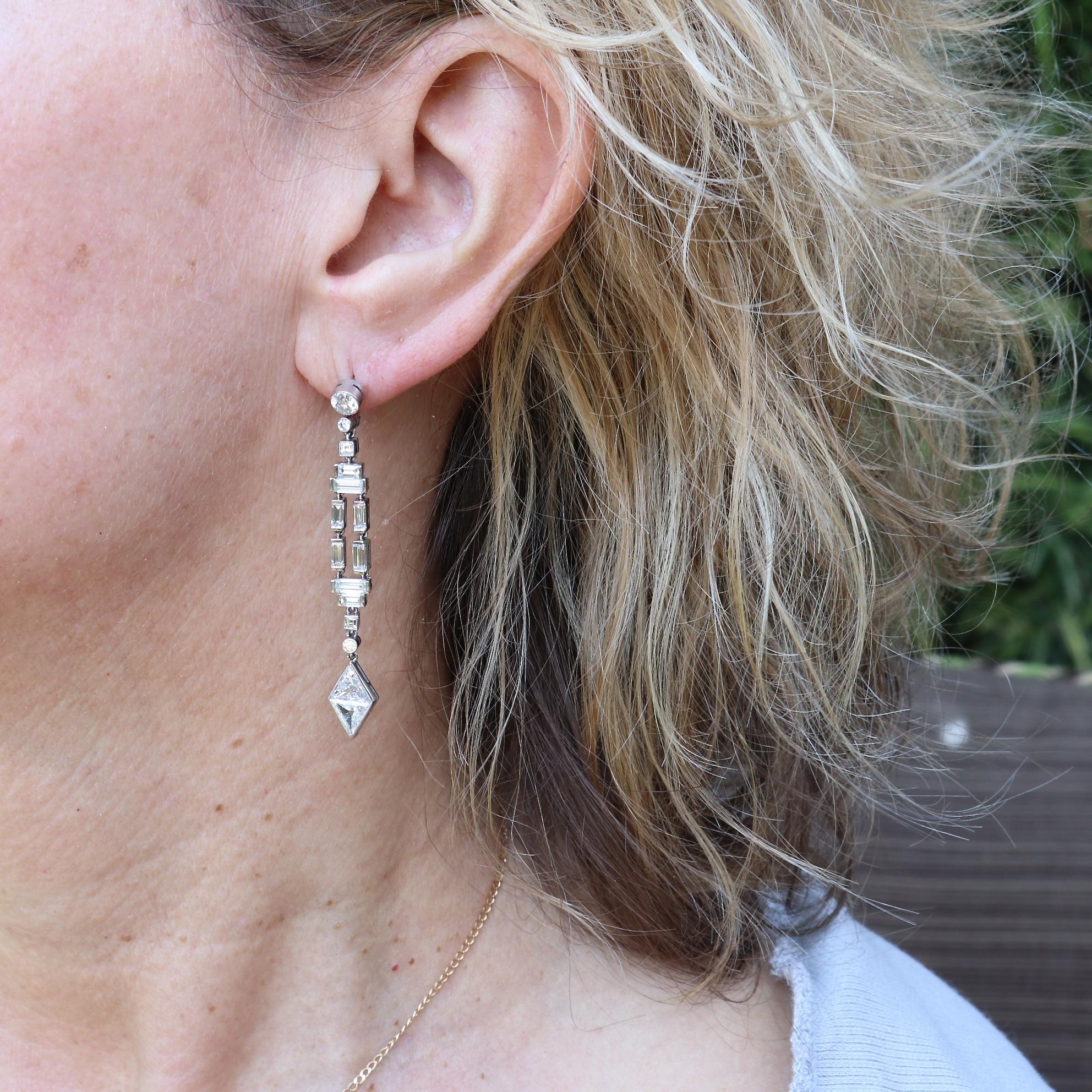 Stunning Art Deco inspired diamond drop earrings with approximately 4.20 carats of diamonds. 
Featuring four antique trillion cut diamonds weighing approximately 0.50 carats each that are F-G color, VS-SI clarity. On top are two old European cut