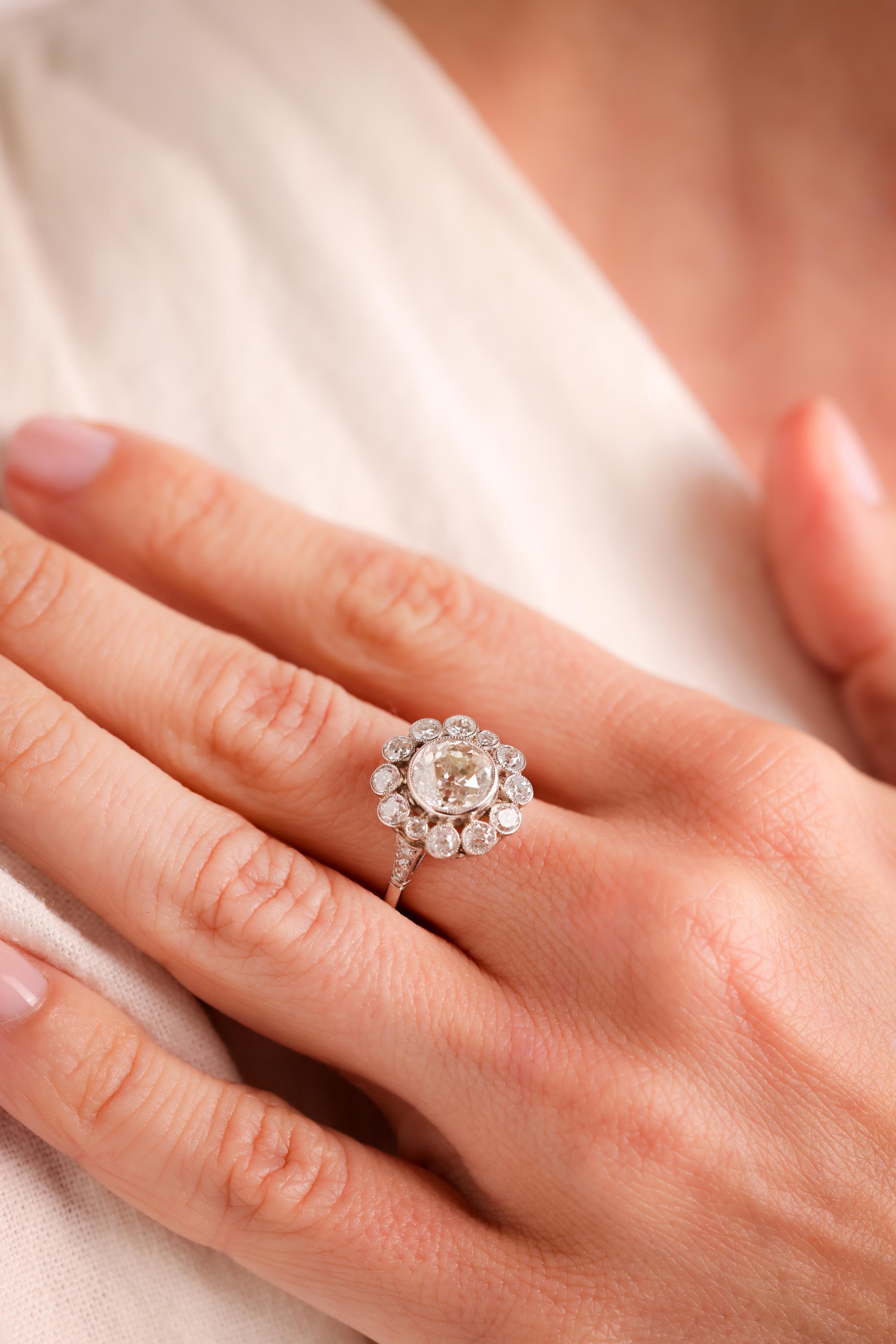 Center Stone: Diamond
Cut: Old European Cut
Weight: 1.25 Carat
Color: L
Clarity: SI
Accent Stone: 16 Diamonds
Cut: Single, Old European, Old Mine and Round Brilliant Cuts
Weight: Approximately 1.5 Carats
Color: I
Clarity: SI
Metal: Platinum
Era: