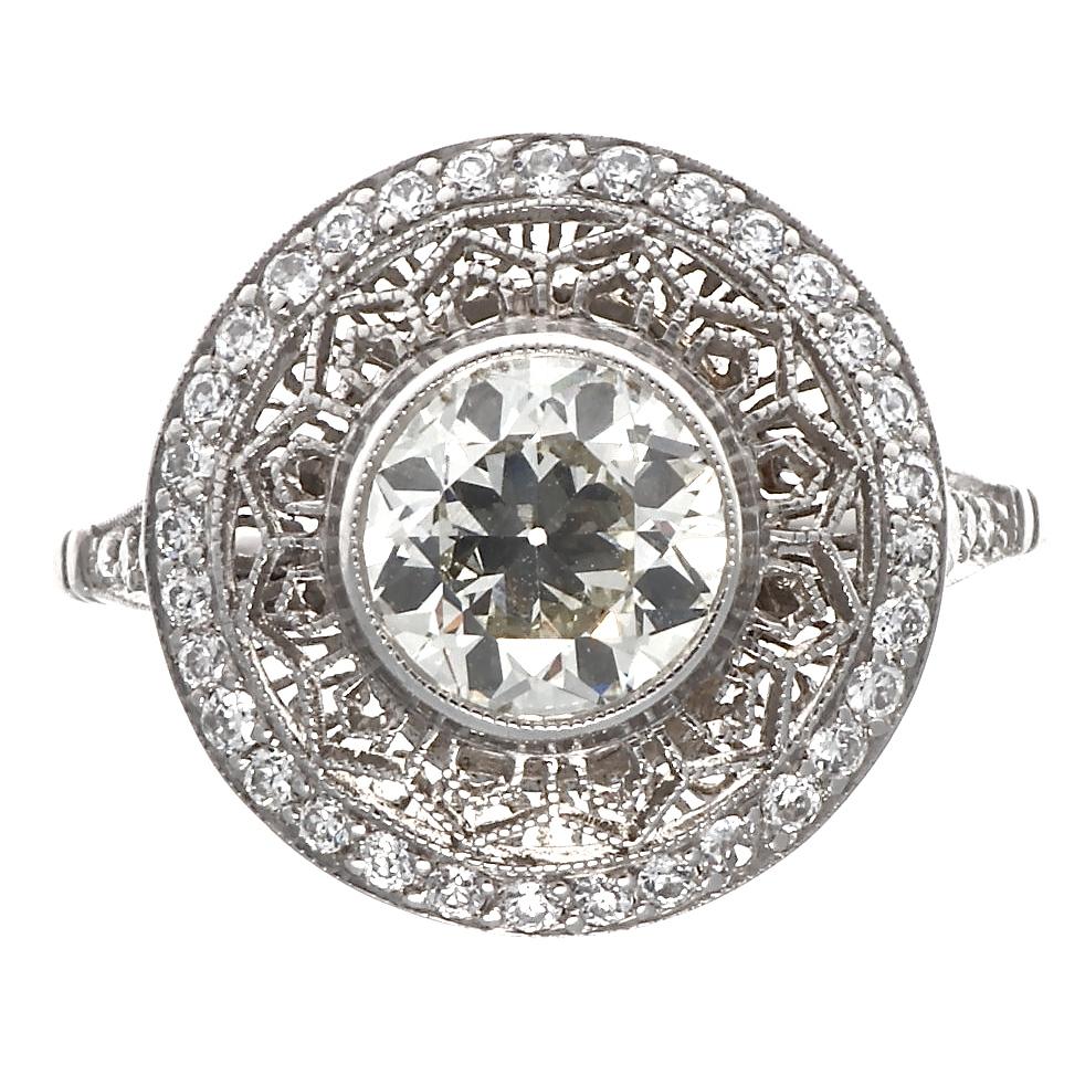 Art Deco inspired, 1.12 carat old European cut diamond surrounded by platinum lace. The center diamond is approximately J-K color, VS2 clarity and contains 38 accenting old European cut diamonds, approximately 0.38 carats with H-I color, VS-SI