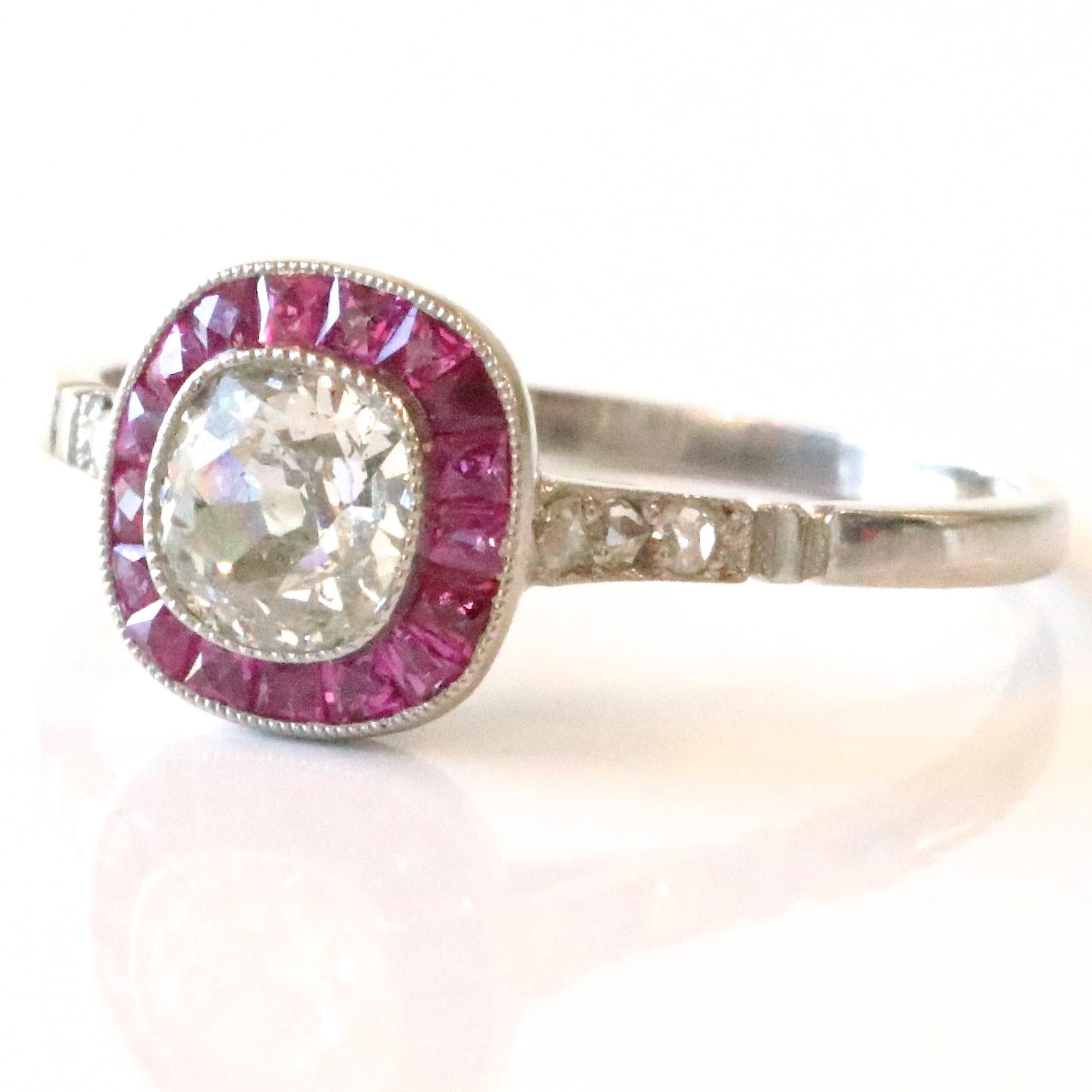 The Art Deco style never gets old! The dancing, the cocktails, the lifestyle, all the things the Roaring 20's are known for. Feel yourself like a 1920's fashionista wearing this gorgeous Art Deco Inspired Diamond Ruby Platinum Ring. The center stone