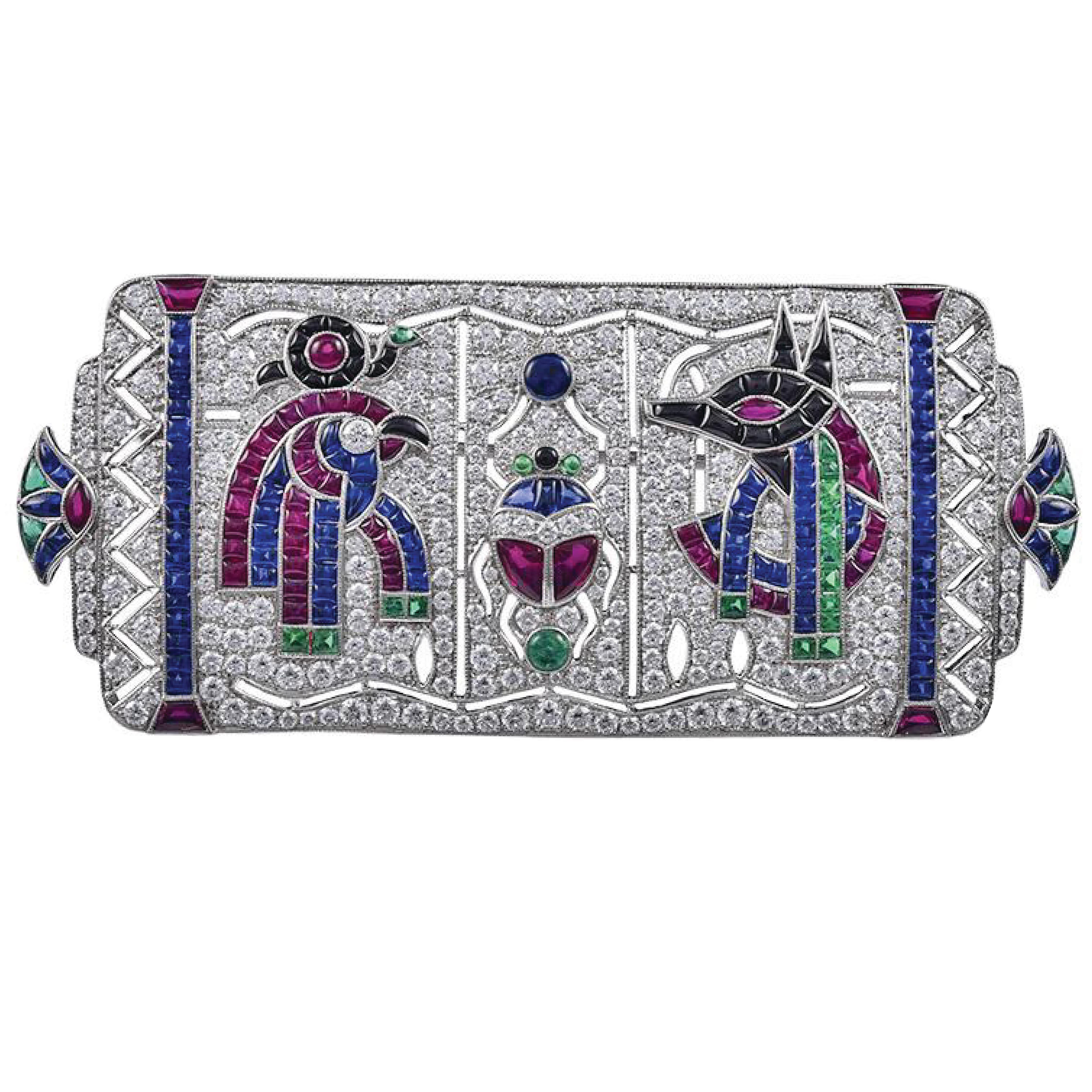 3.49 Carat Art Deco Inspired Egyptian Revival Platinum Brooch with Sapphire, Emerald, Ruby, and Diamonds. 
Total carat weight: 
Sapphires 5.03 carats
Emeralds 1.06 carats
Rubies 3.96 carats 
Diamonds 3.49 carats.