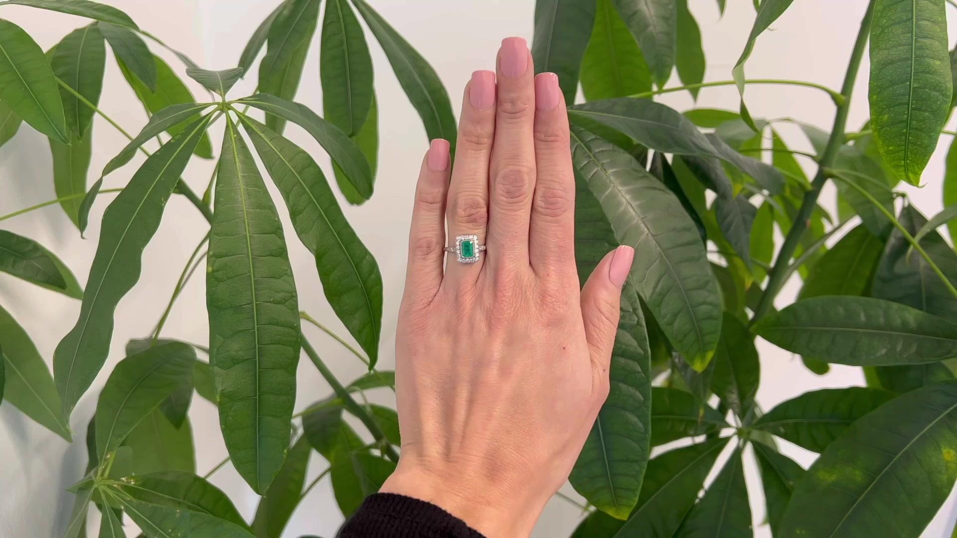One Art Deco Inspired Emerald Diamond Platinum Ring. Featuring one octagonal step cut emerald of 0.64 carat. Accented by 22 old European cut diamonds with a total weight of approximately 0.45 carats, graded G-H color, VS clarity. Crafted in