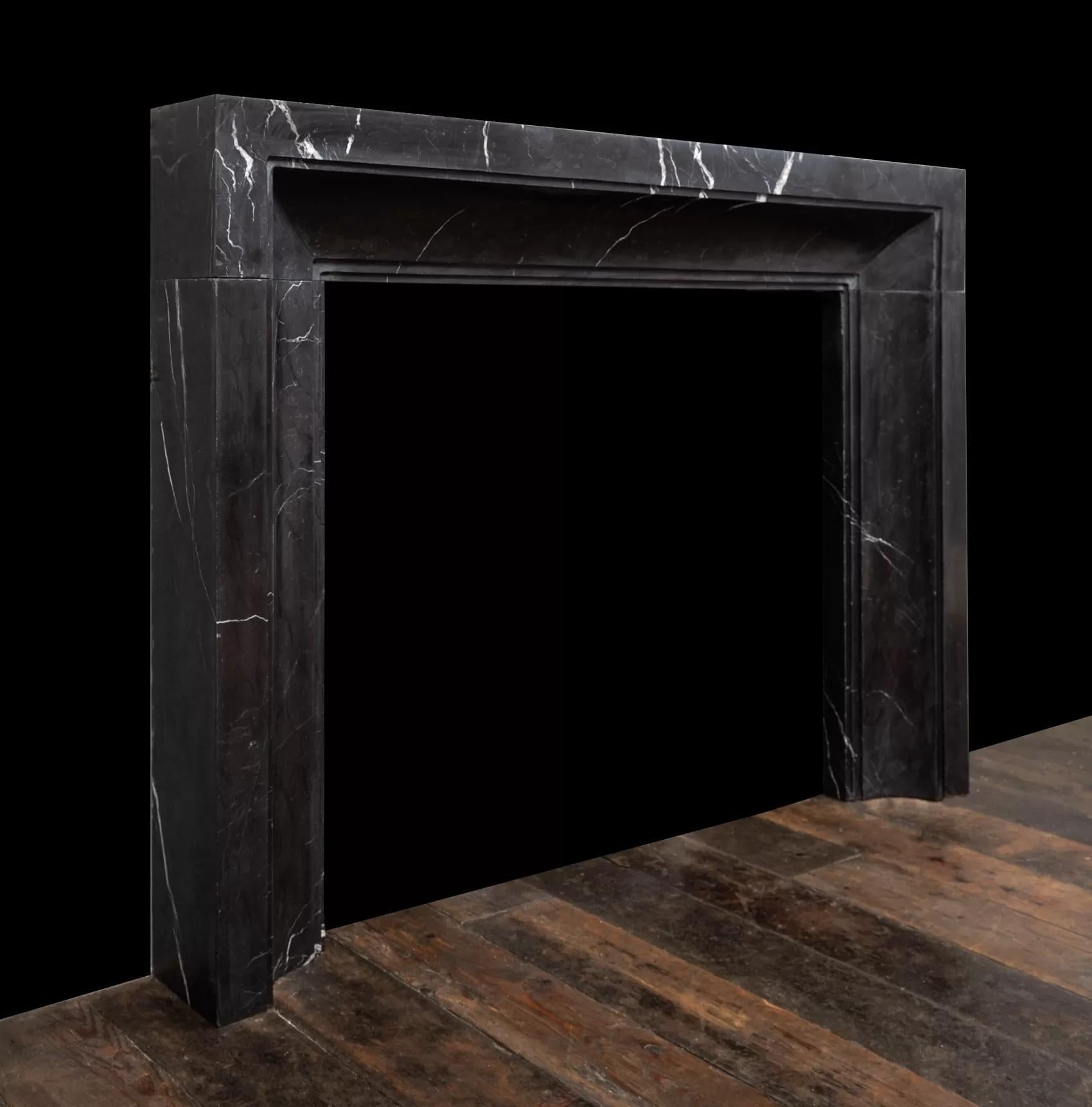 An Art Deco inspired fireplace surround made in black and white Nero Marquina marble.

Produced in three solid blocks of carefully selected black Marquina marble, with subtle white markings that flow in the direction of the fireplace