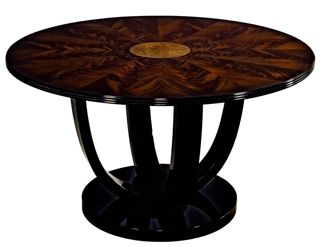Carrocel custom Art Deco foyer center hall dining table. Flamed mahogany sunburst top with a burl center insert atop an Art Deco hand polished black lacquer base.
Price includes complimentary curb side delivery in the continental USA.