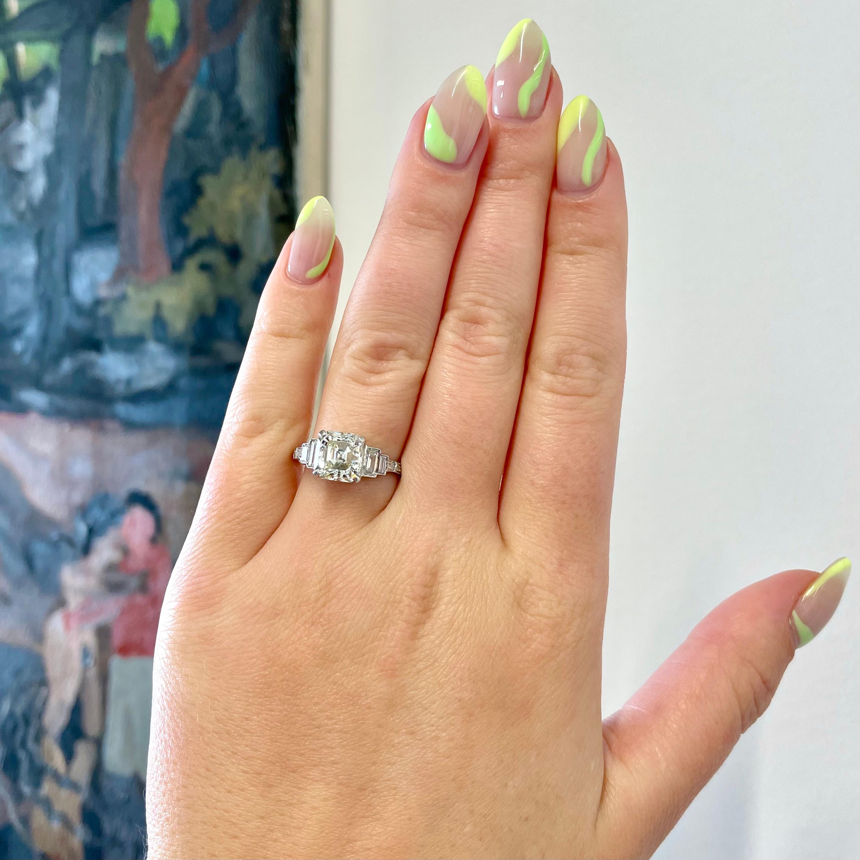 Art Deco Inspired GIA 2.86 Carat Square Emerald Diamond Platinum Engagement Ring. The center diamond is a GIA certified square emerald cut 2.86 carat, L color, VS2 clarity (#6213300294). Accented by 6 baguettes, 4 Round Brilliant Cut diamonds 0.45