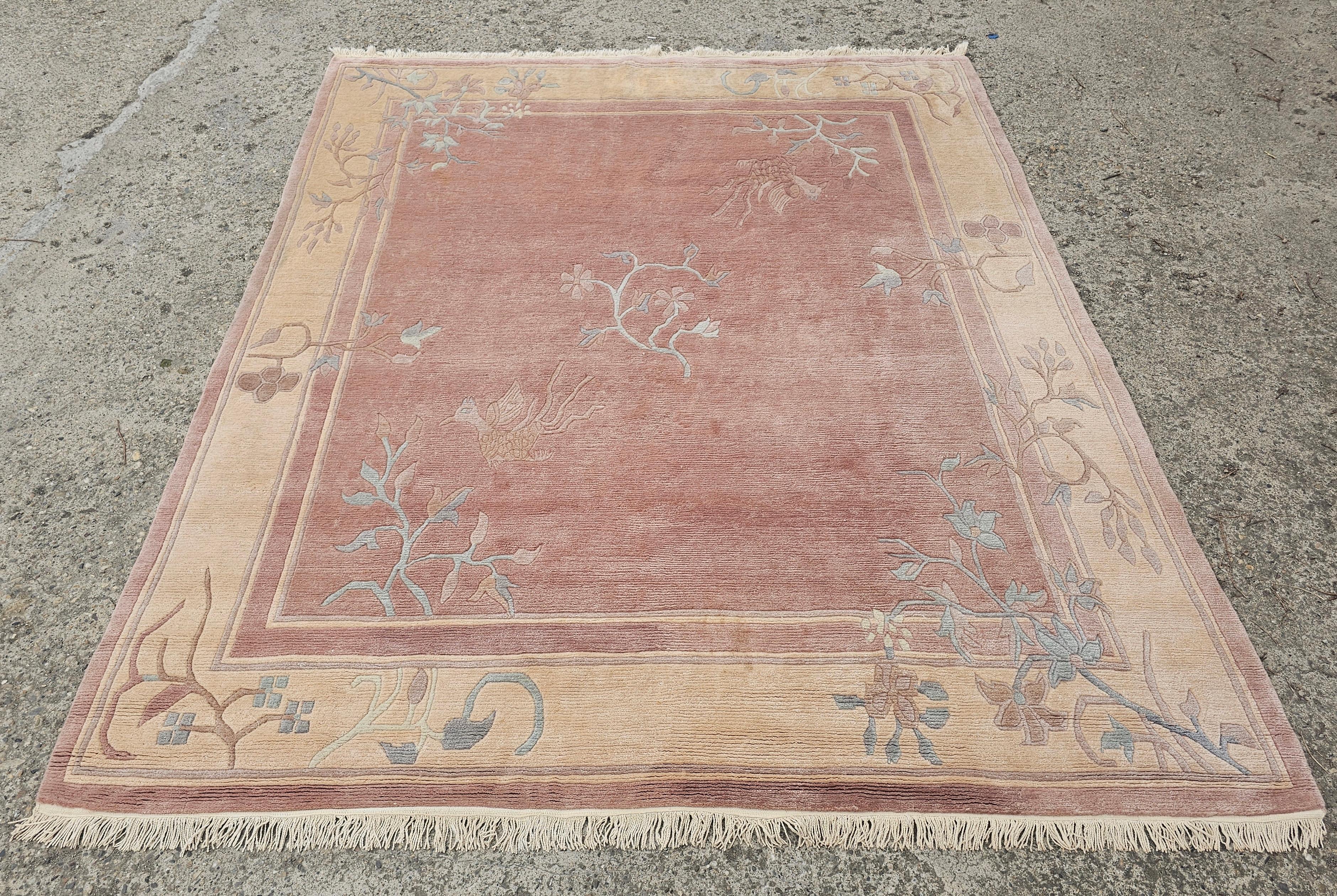 In questa inserzione troverai un tappeto di ispirazione Art Déco, con motivi animali e floreali. Questo tappeto annodato a mano è realizzato in lana rosa polveroso e crema. Il suo calore e il suo design raffinato aggiungeranno fascino e carattere a