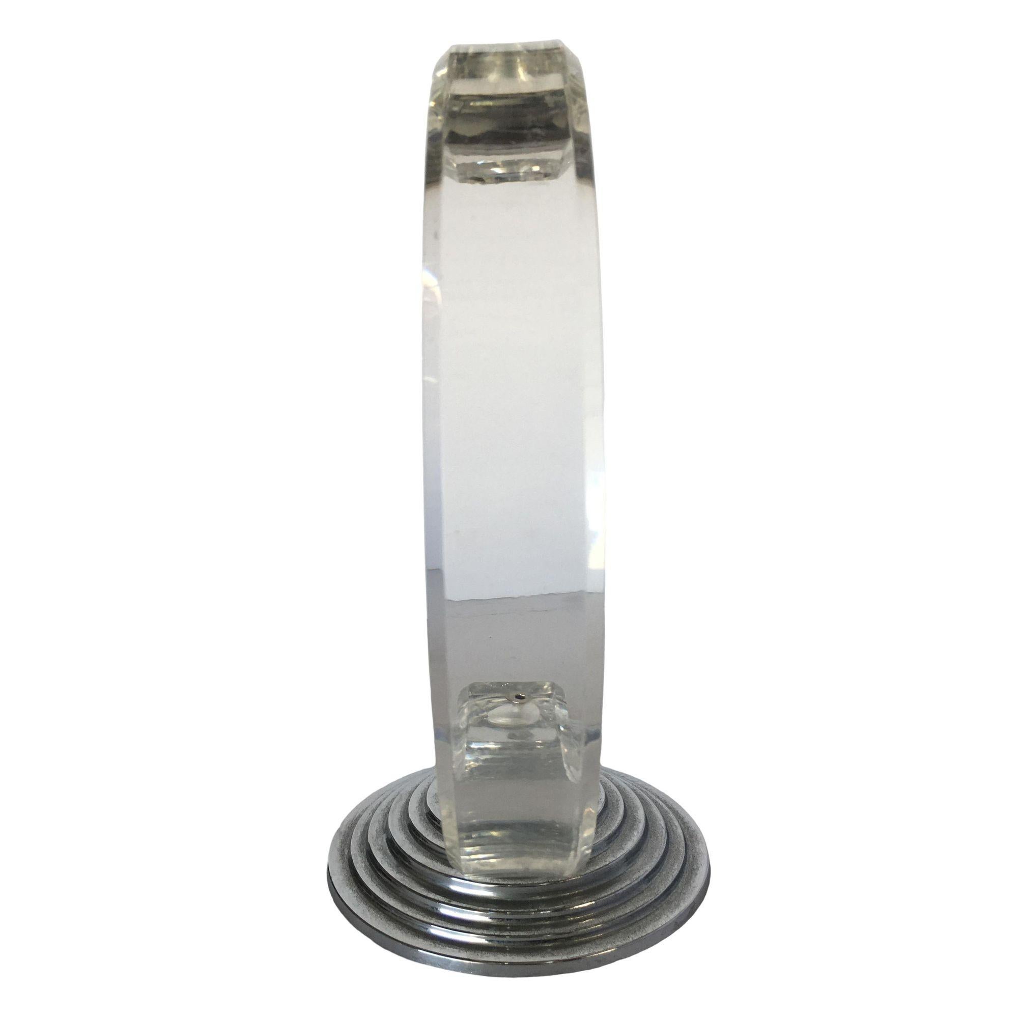 Art Deco inspired candlestick holder with a shaped piece of Lucite fixed to stepped Art Deco base.