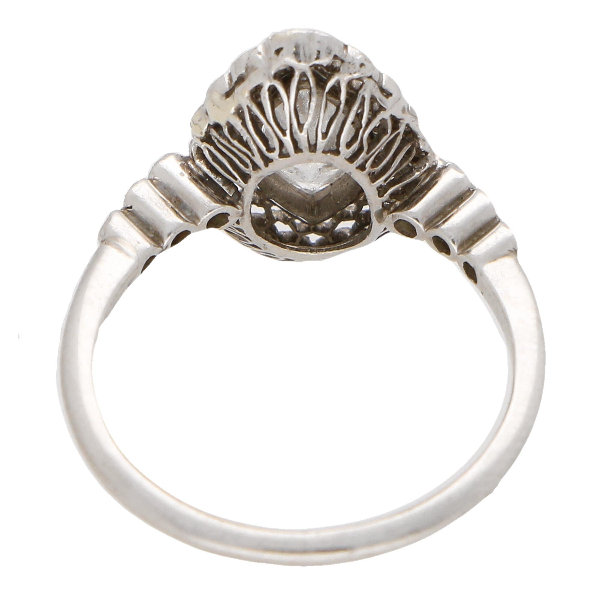 A beautiful Art Deco inspired vintage marquise cut diamond cluster ring set in platinum.

The piece is predominantly set with a sparkly marquise cut diamond which is collet set securely to center. Surrounding this stone is a beautiful display of