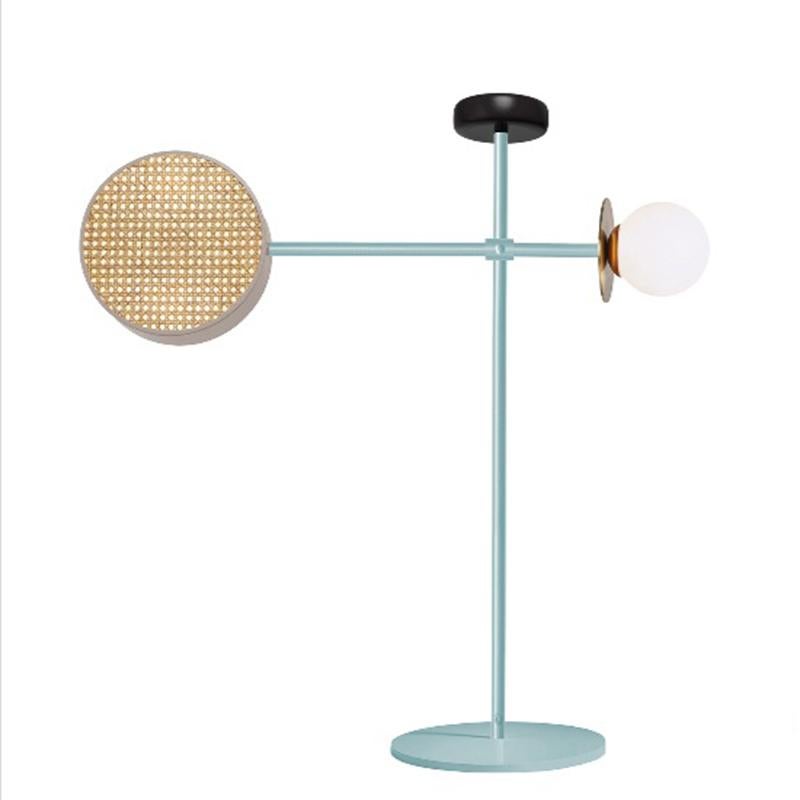 Monaco Floor, with its articulate arm that can be adjusted at different positions, is a mobile-like creation that mix a handful of materials we love: rattan mesh, wooden detail and brass details intertwined with delicate and opal glass globes, in a