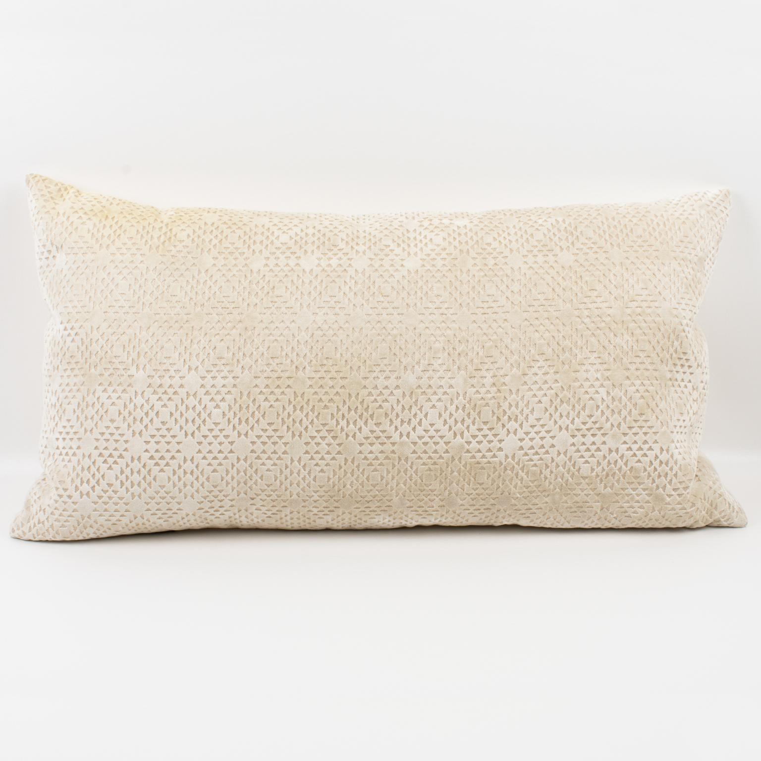 This lovely Art Deco-inspired velvet throw pillow features a lumbar-shaped pillow, covered on the front with a textured geometric design in off-white velvet. The back is made of the same colored velvet with a plain design. A zipper encloses an inner