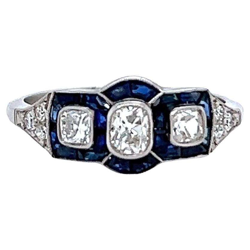 Art Deco Inspired 0.65 Carat Old Cut Diamond Sapphire Platinum Three Stone Ring For Sale