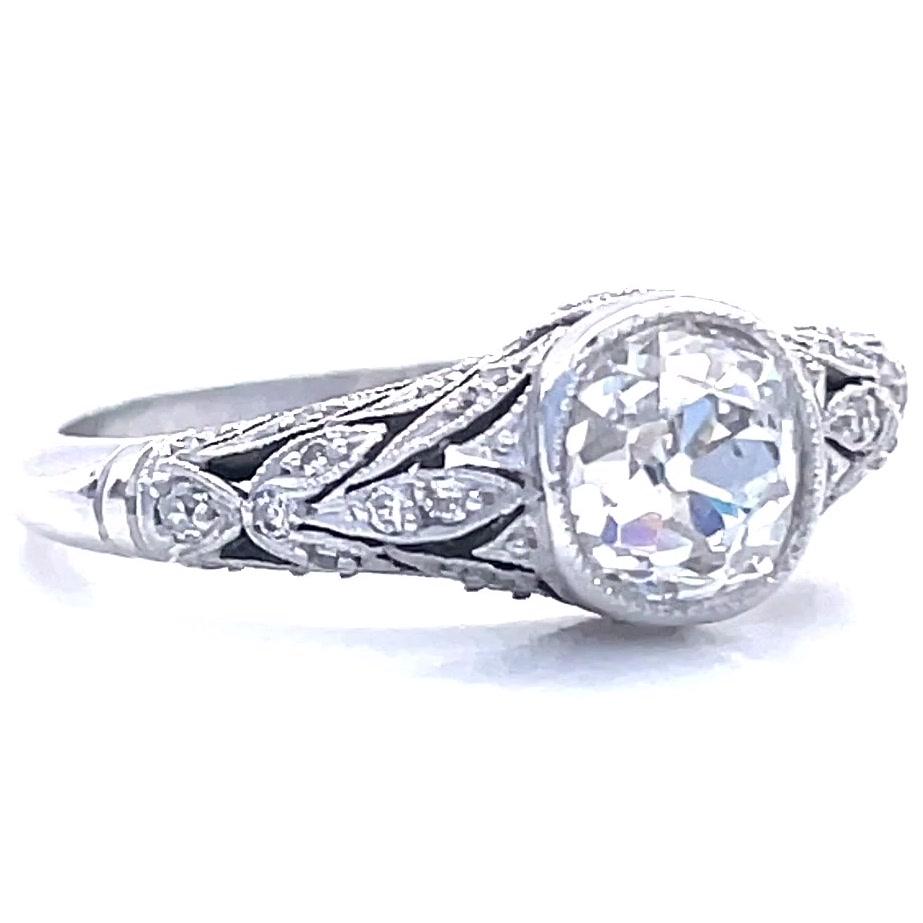 Timeless and classic, with filigree detail and mill grain edged bezel, this Art Deco Inspired ring features a 0.97 carat old European cut diamond that creates a dazzling show within its platinum setting. Accented with 32 old European cut diamonds,