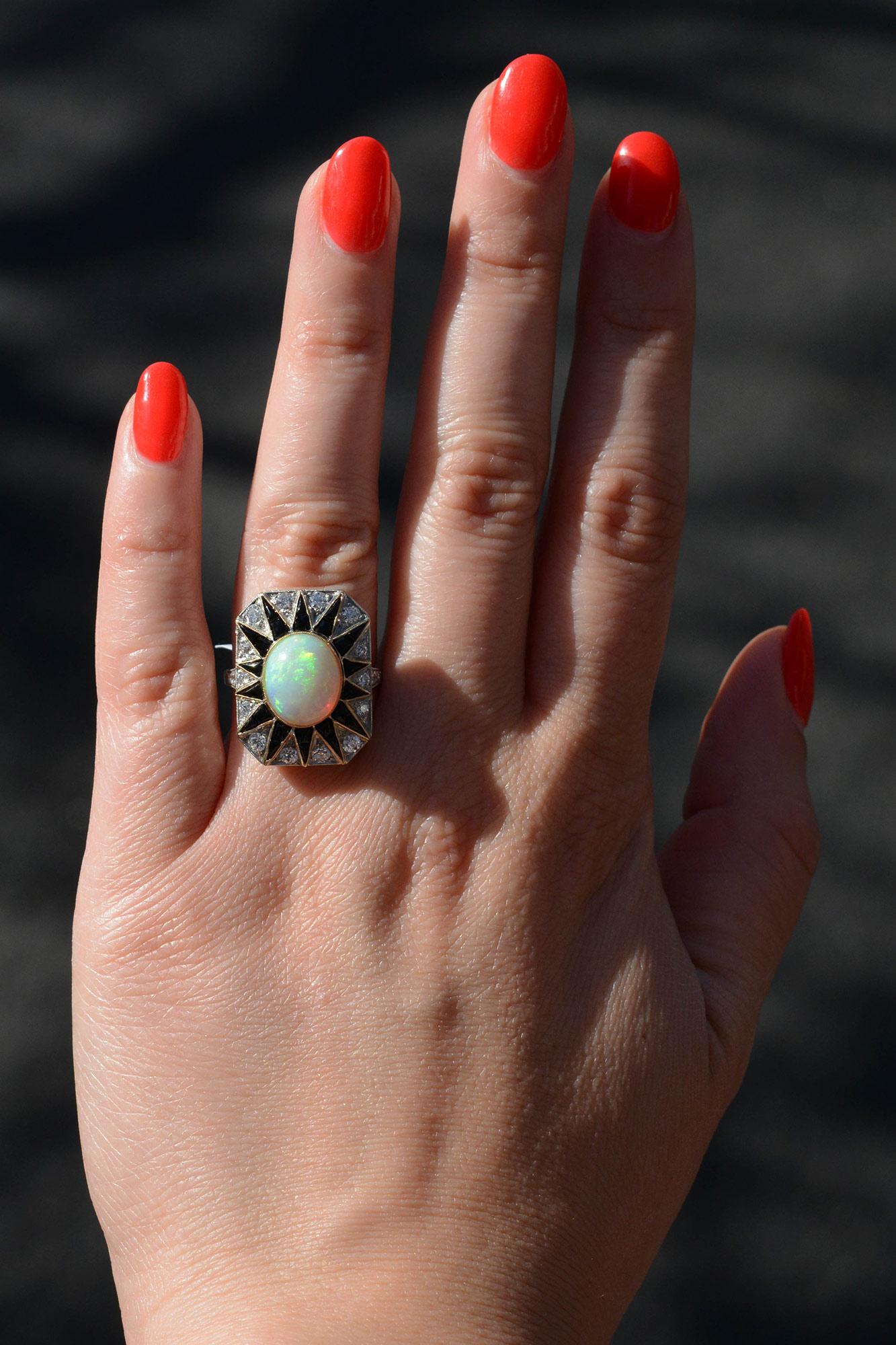 Capture your unique style with this beautiful 2.82 carat opal cocktail ring. Perfect for a statement piece, this mysterious, Art Deco inspired ring features an exotic Australian fiery opal with a fabulous play of color and a streamlined sunburst
