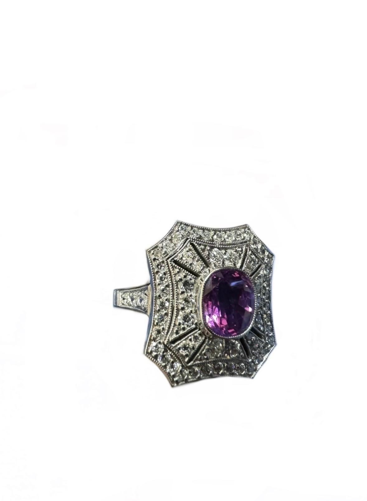 DeKara Designs Collection

Art Deco Inspired Extremely Elegant Handmade Vivid Pink Antique Style Diamond Engagement Ring.

Metal- 90% Platinum, 10% Iridium.

Stones- Oval Vivid Pink Sapphire 1.57 Carats, 60 Old European Cut Round Diamonds F-G Color