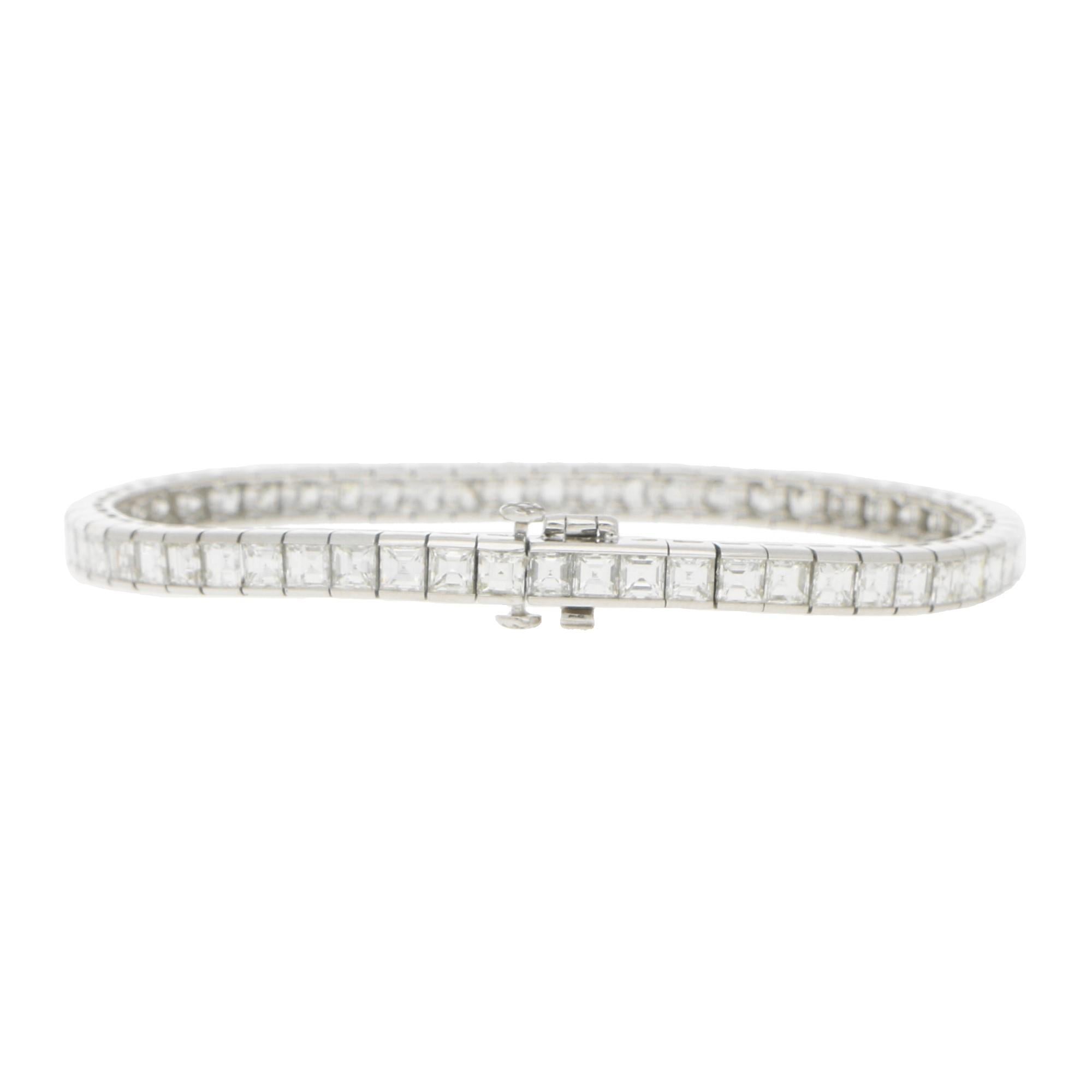 An elegant princess cut diamond line bracelet set in platinum. 

This is a beautiful example of a modern take on the traditional line bracelet and is composed with exactly 58 princess cut diamonds. Each diamond is set in a rub-over articulated