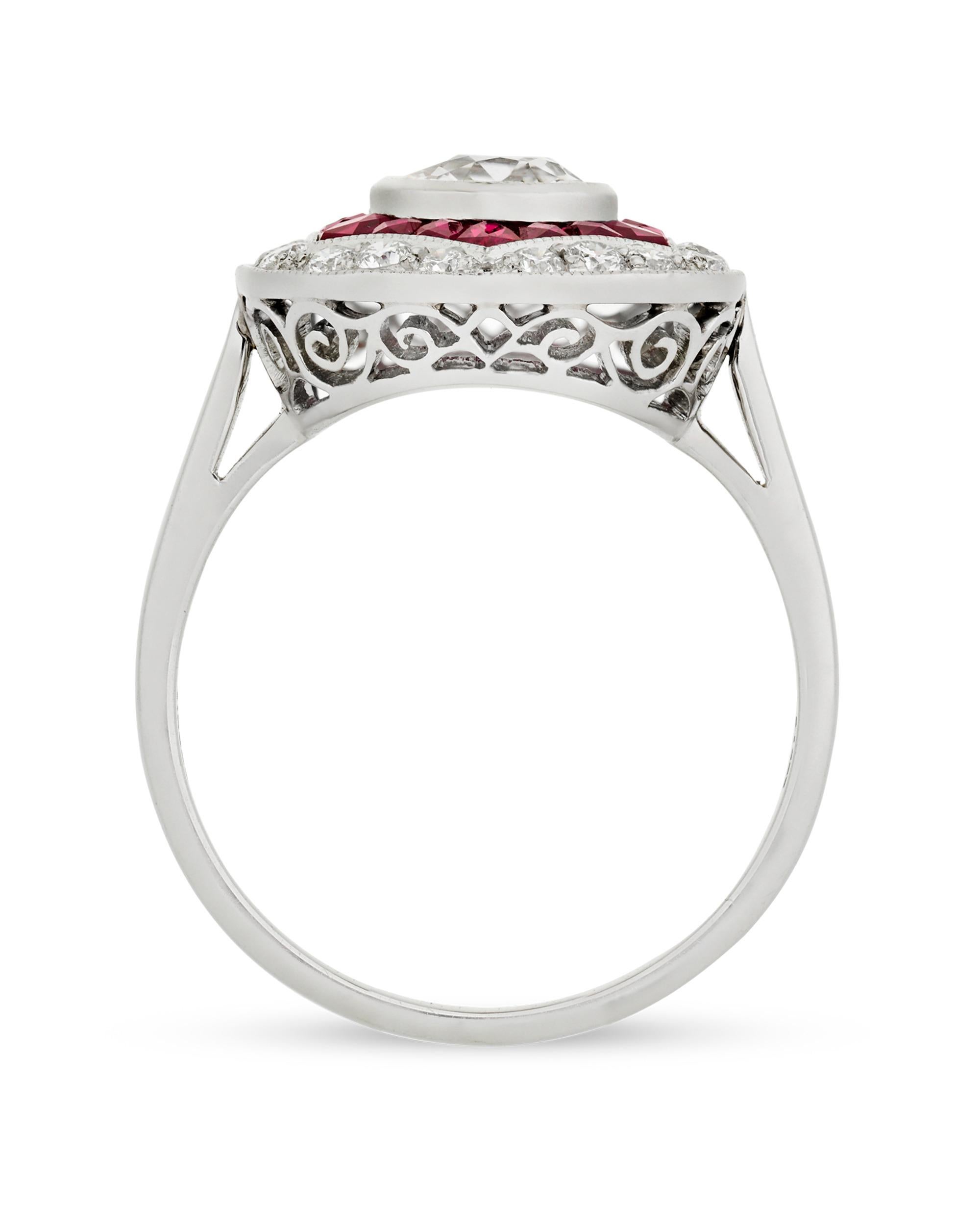 Art Deco-era elegance is beautifully reflected in this ruby and diamond platinum ring. The 0.82-carat round center diamond is boldly bordered by 1.57 total carats of ravishing red rubies and 0.33 additional carat of glistening diamonds. This