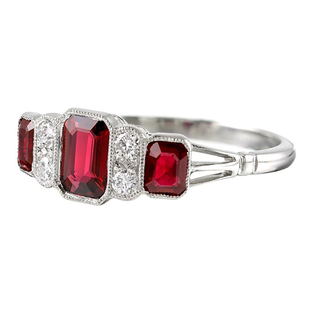 A modern rendering inspired by classic art deco style, this platinum ring offers a lovely low profile on the finger, making it ideal for daily wear. Set with 1.22 carats of rubies and .14 carats of brilliant white diamonds. Note the mill grain