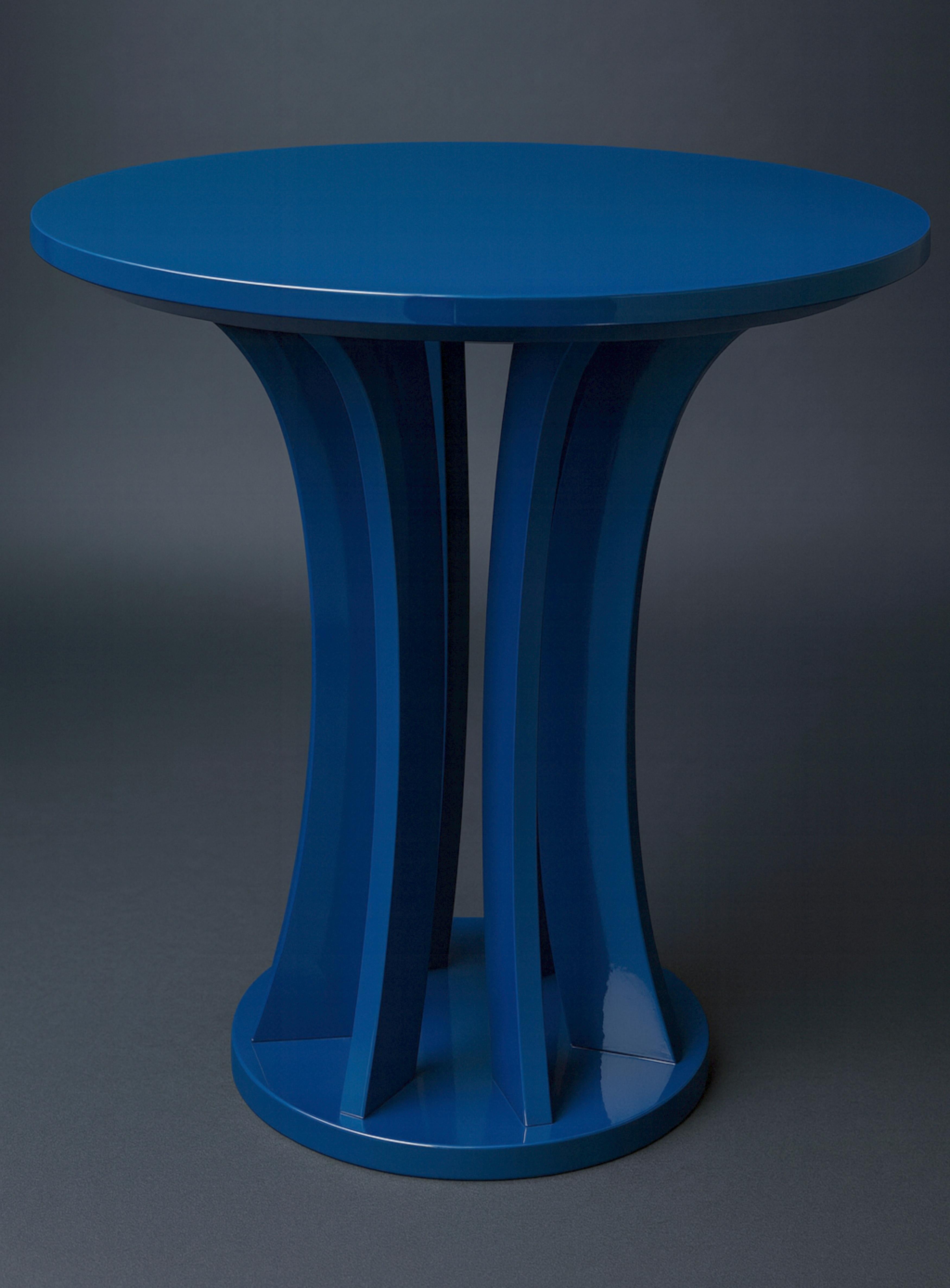 A refined French Sapphire Blue Art Deco inspired side table from the 20th century, finished in lustrous varnish and supported by gracefully rounded legs. Its bold geometric silhouette adds a touch of sophistication to any elegant interior.