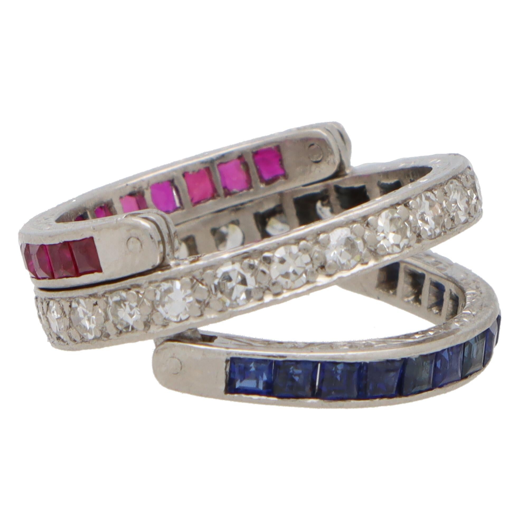 A unique Art Deco inspired sapphire, ruby and diamond convertible flip ring set in platinum. 

This piece is an excellent example of the Art Deco style. Firstly, the central band is set with 24 round brilliant cut diamonds which are claw set