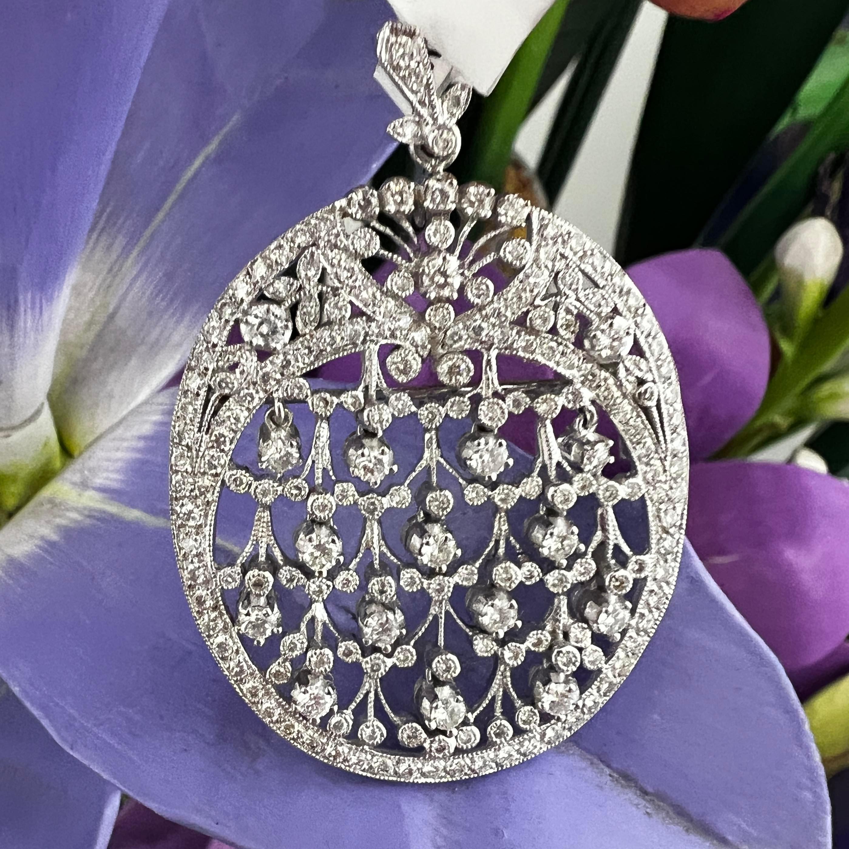 Exquisite diamond Art Deco-inspired Pin Pendant, by Sonia B., a true masterpiece that effortlessly captures the essence of timeless elegance. Crafted in 18k white gold with meticulous attention to detail, this large oval-shaped accessory perfectly