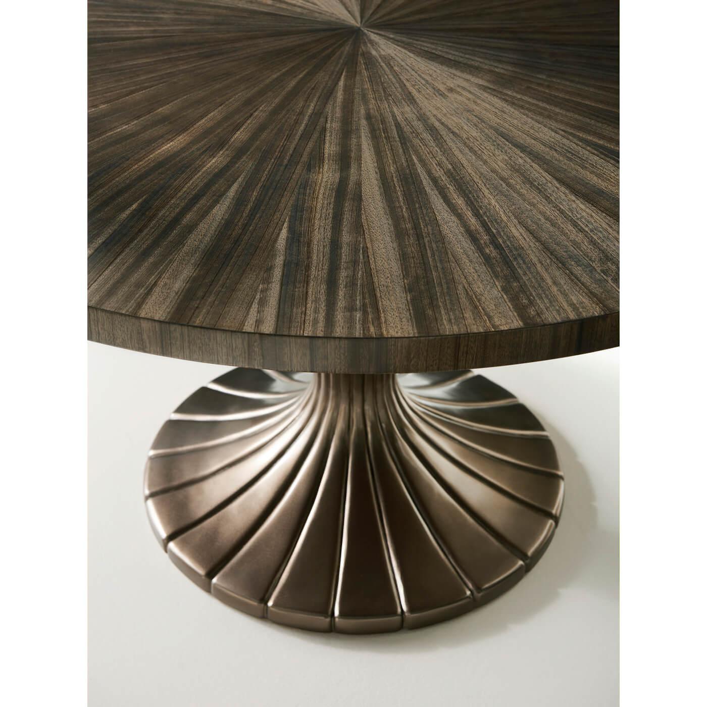 An Art Deco-inspired round dining table with a composite fluted vasiform base in a bronzed finish. This beautiful table has a radial-matched, soft Sepia-finished Paldoa tabletop. This table pairs well with contemporary or more traditional chairs and