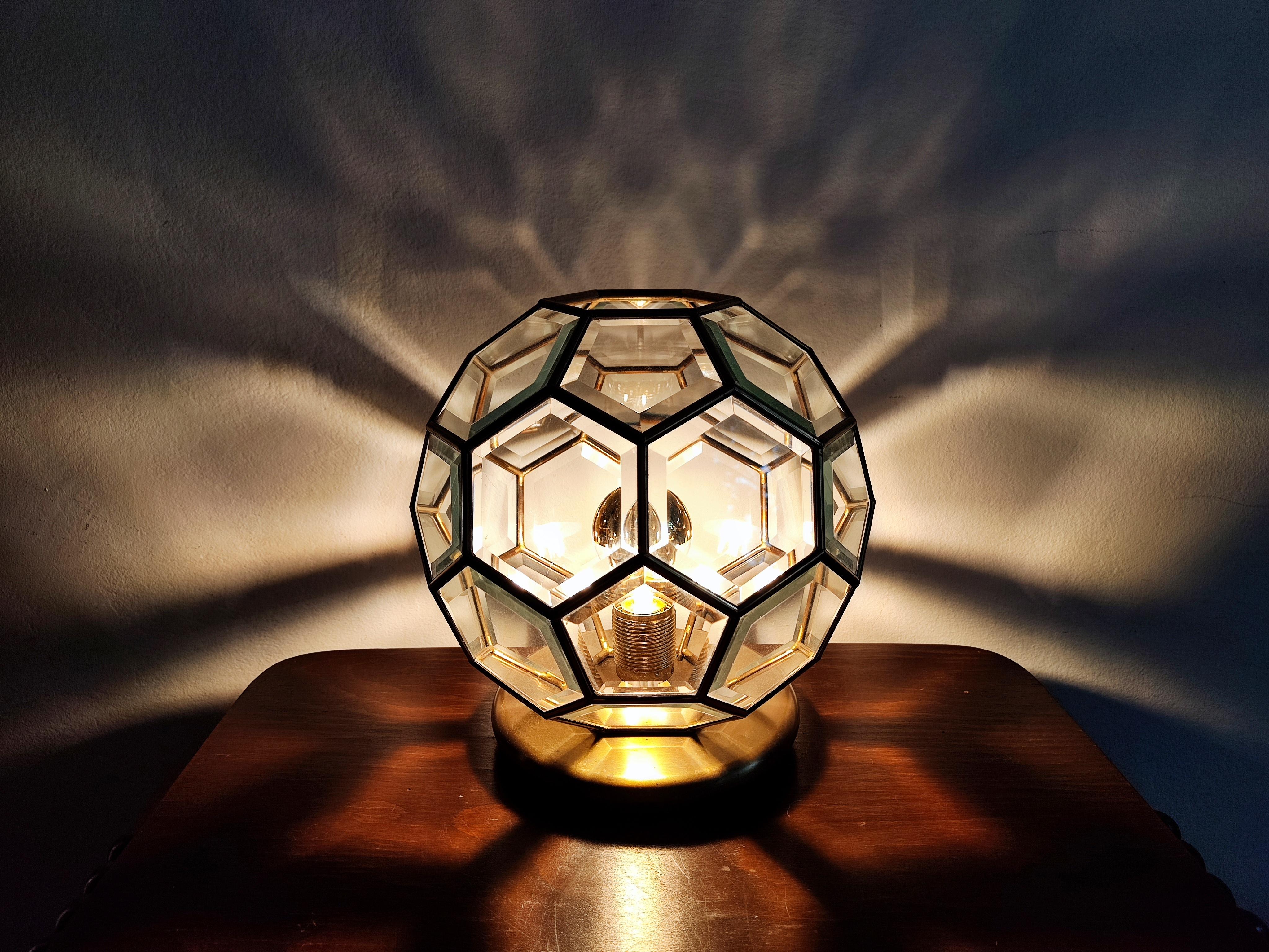 In this listing you will find a gorgeous handmade table lamp in Adolf Loos style. The lamp is inspired by Art Deco style. It is done in brass and faceted glass. 

The shape of the lamp is known in geometry as Truncated Icosahedron, which became
