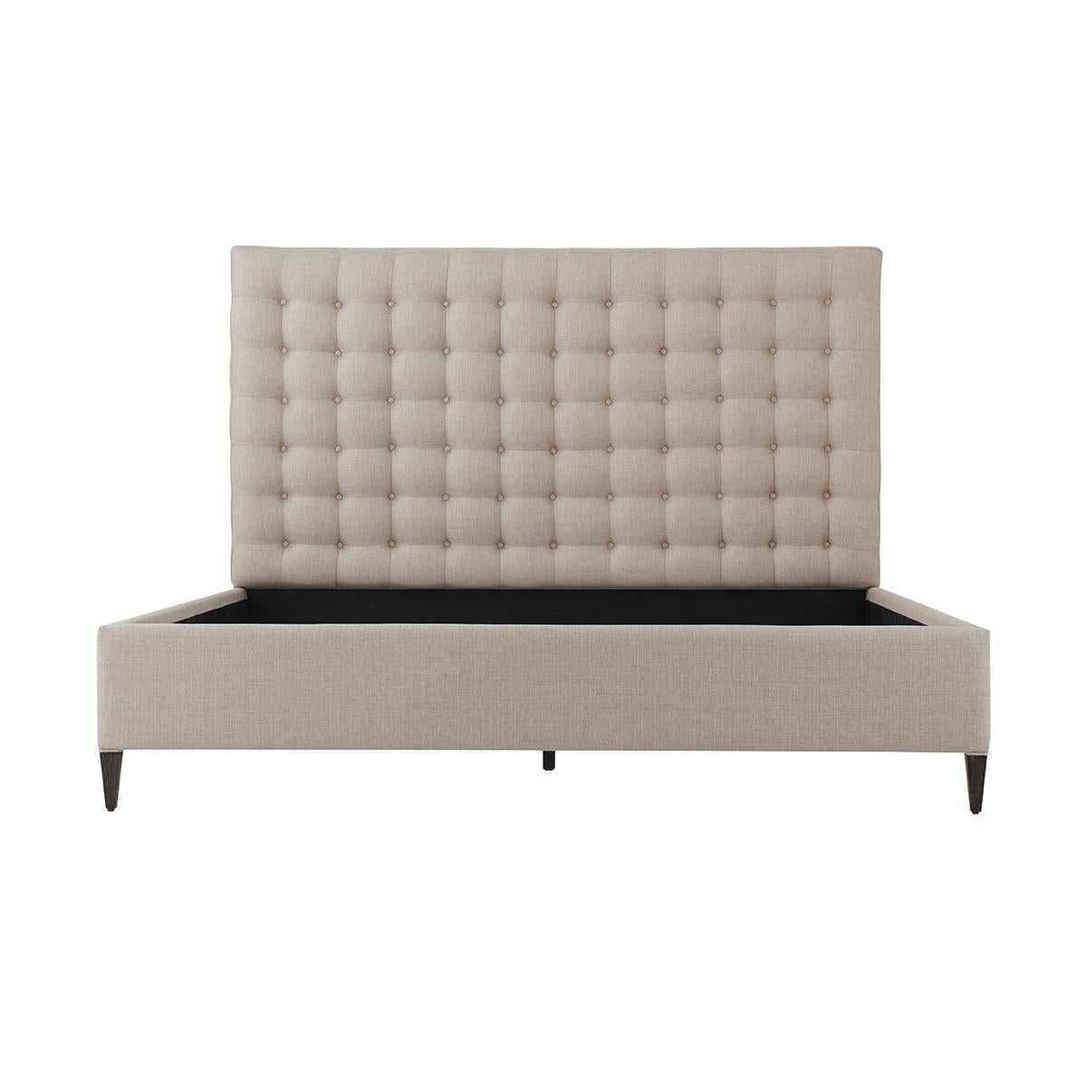 With a biscuit tufted headboard with upholstered rails and raised on square tapered legs.

Dimensions: 81